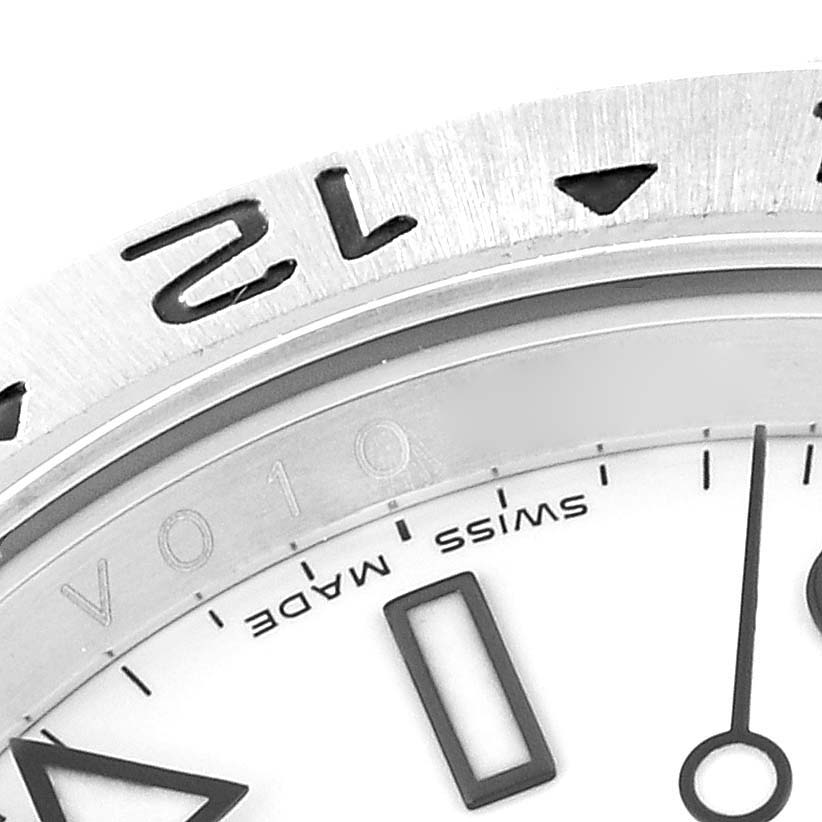 This image shows a close-up of the dial, bezel, and part of the 12 o'clock marker on a Rolex Explorer 16570 Men's Stainless Steel White Dial 16570 Men's Stainless Steel White Dial watch.
