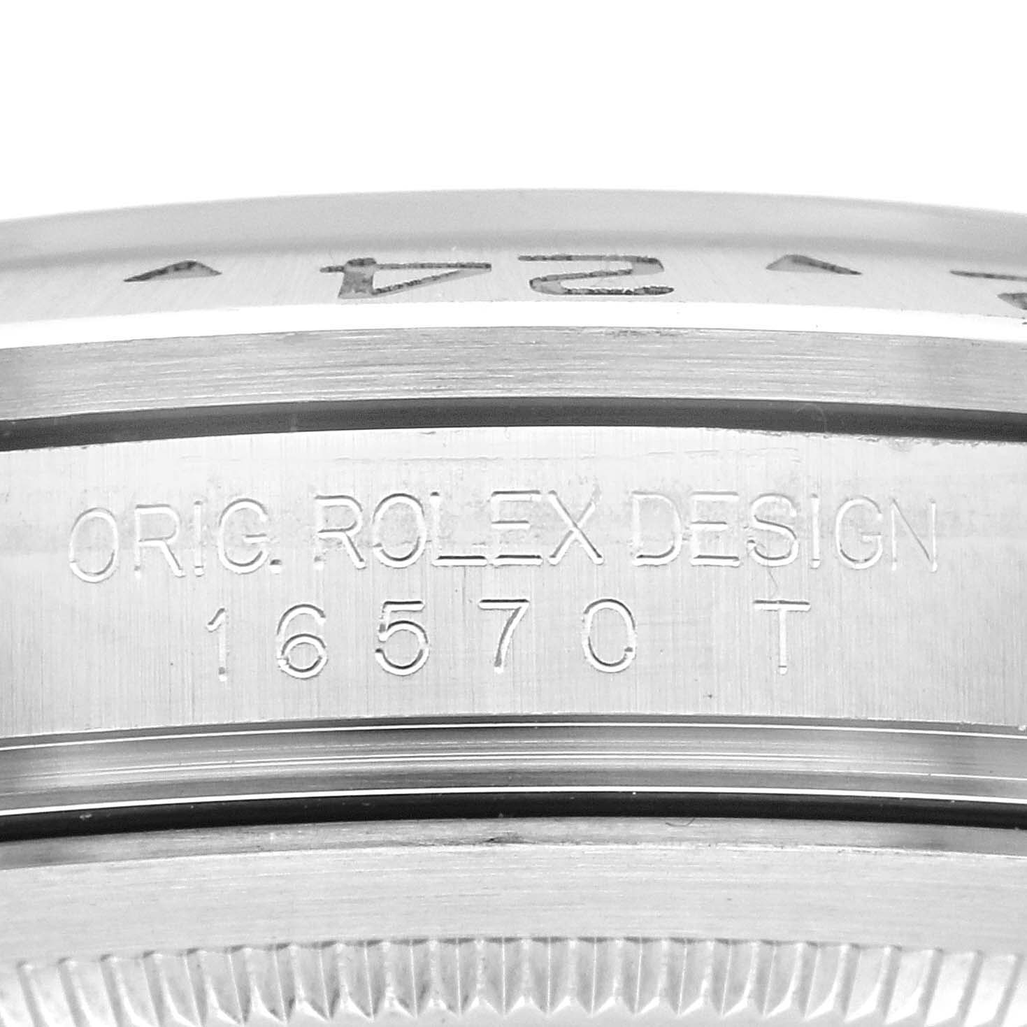 The image shows a close-up of the case side on a Rolex Explorer 16570 Men's Stainless Steel White Dial 16570 Men's Stainless Steel White Dial model, displaying the engraving with the design and model number "16570 T."