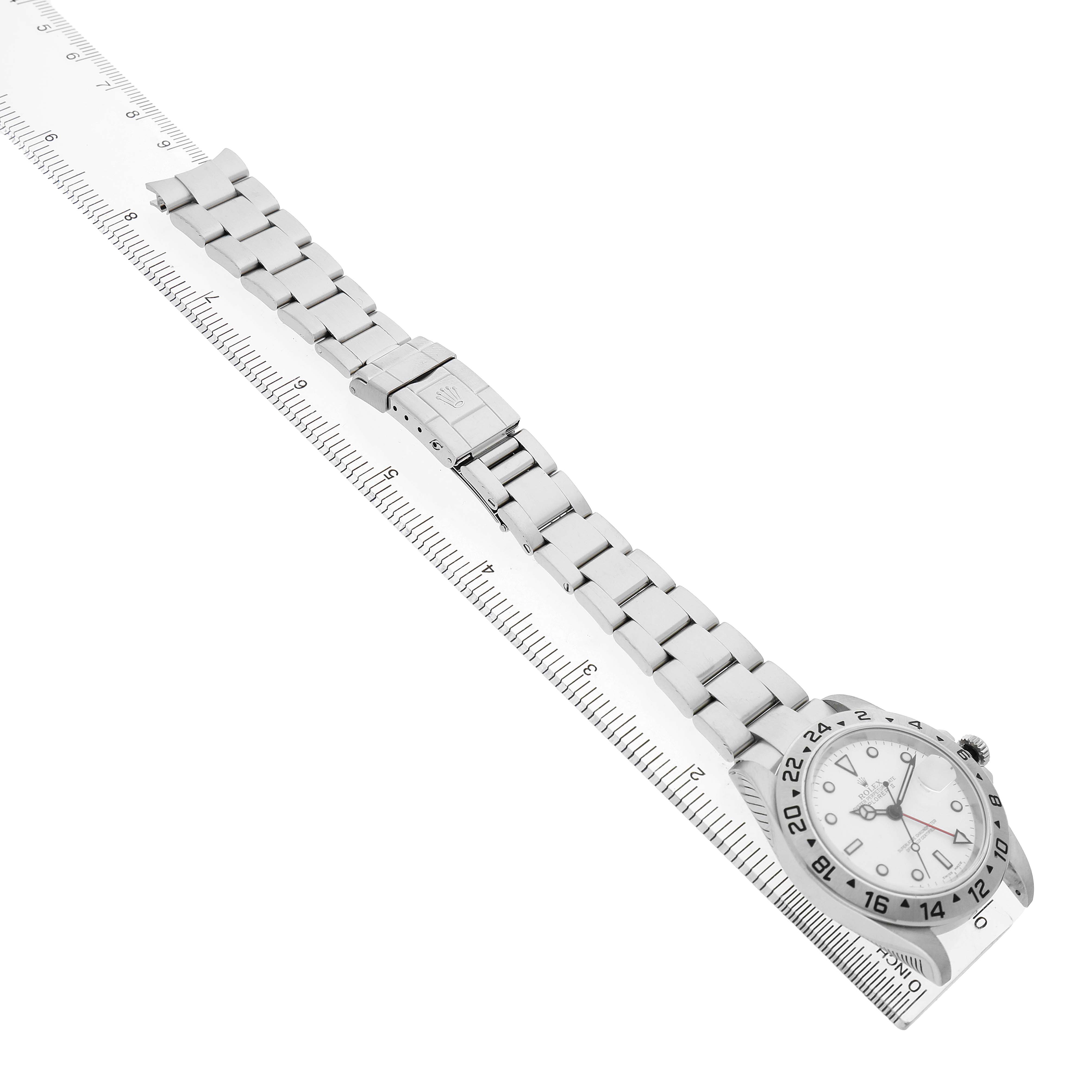 The Rolex Explorer 16570 Men's Stainless Steel White Dial watch is shown at an overhead angle, displaying the bracelet, clasp, and part of the bezel and dial.