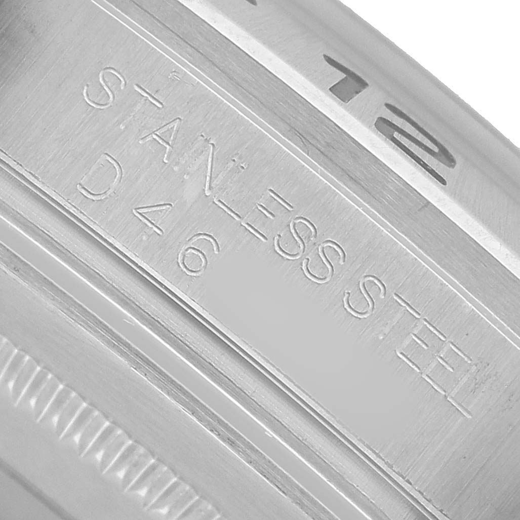 The image shows the edge of a Rolex Explorer 16570 Men's Stainless Steel White Dial watch focusing on the stainless steel engraving.