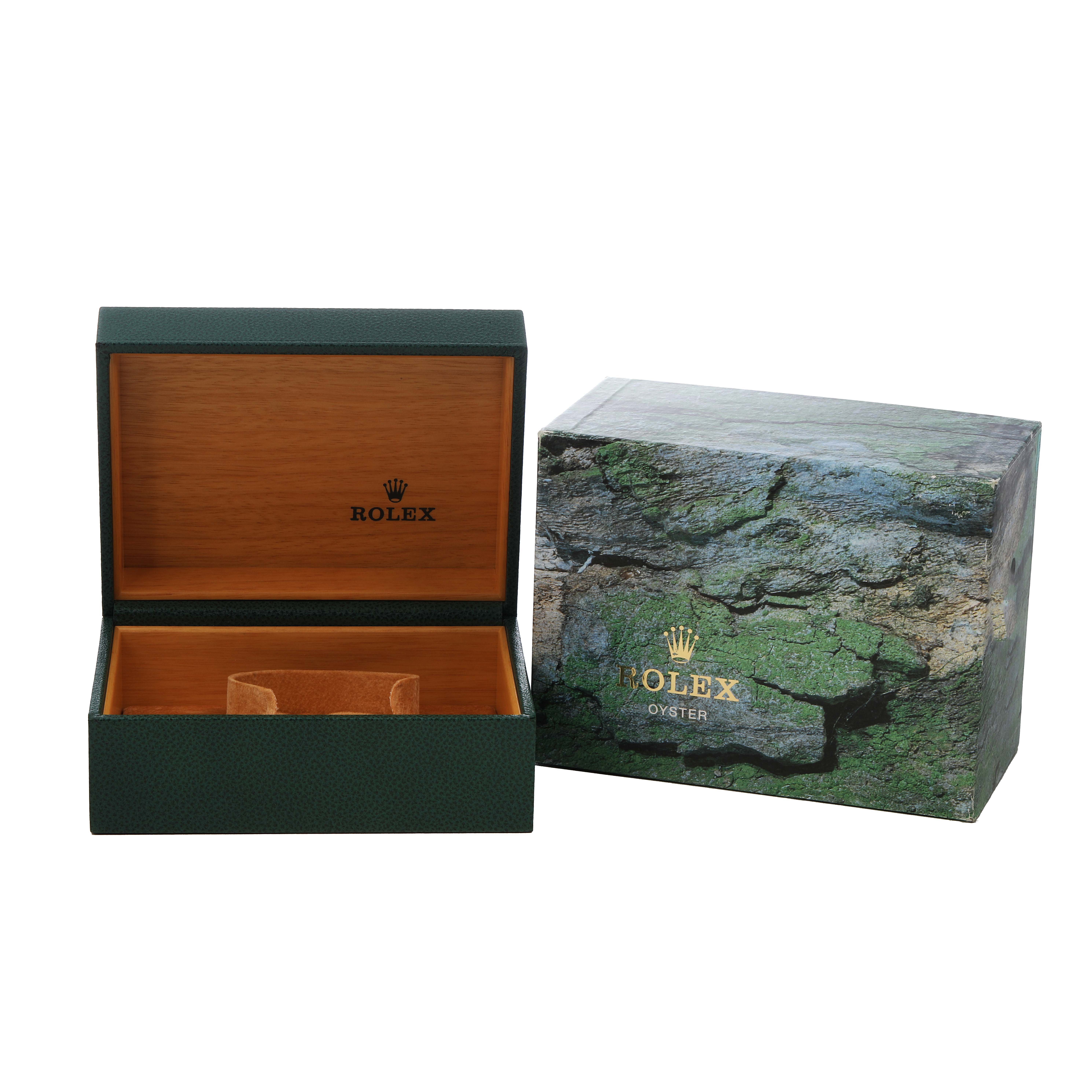 The image shows an open Rolex Explorer 16570 Men's Stainless Steel White Dial box and an outer box with a green textured design.