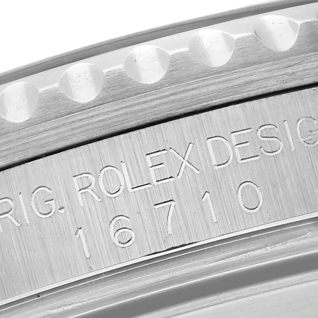 The image shows a close-up angle of the Rolex GMT-Master 16710 Men
s Stainless Steel Black Dial 16710 Men
s Stainless Steel Black Dial
s case with the engraved model number "16710."