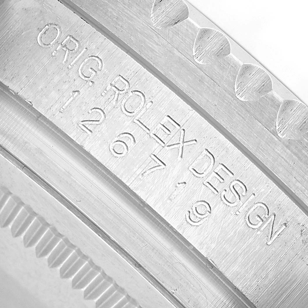 The image shows a close-up of the case side, highlighting the engraved "ORIG ROLEX DESIGN" on the GMT-Master model by Rolex.