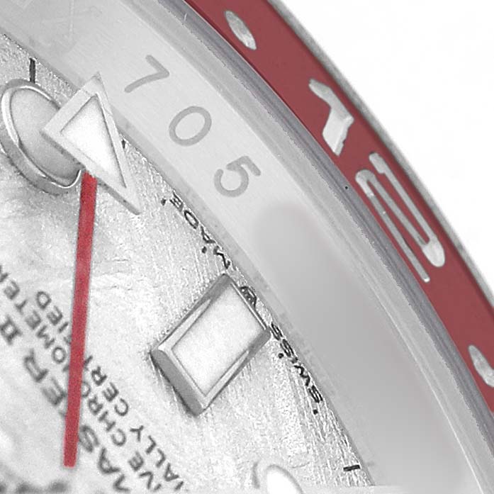 This close-up of a Rolex GMT-Master 126719BLRO Men's White Gold Silver Dial watch shows the bezel, part of the dial, and the GMT hand.