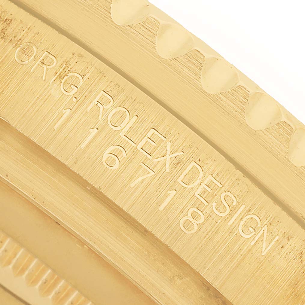 The image shows a close-up of the side engraving on a Rolex GMT-Master 116718 Men's Yellow Gold Green Dial bezel with the model number "16718" visible.
