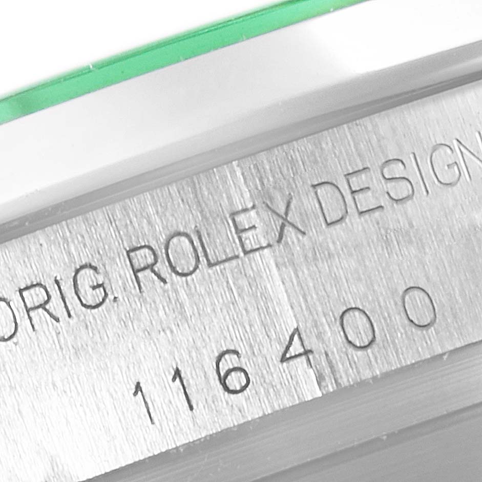 This close-up image shows the engraved serial number "116400" and "ORIG. ROLEX DESIGN" on the case of a Rolex Milgauss 116400GV Men's Stainless Steel Black Dial 116400GV Men's Stainless Steel Black Dial watch.