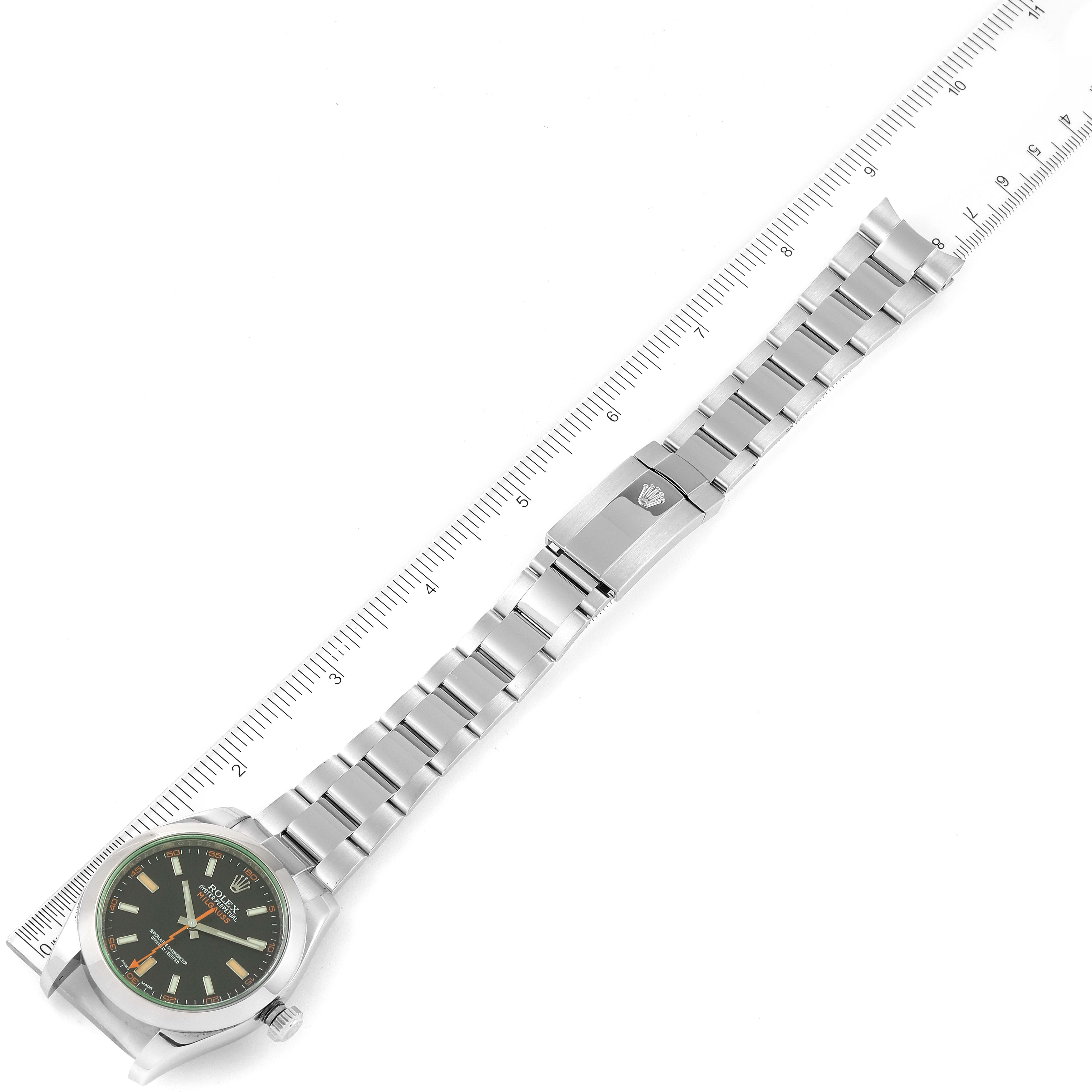The image shows a top-down view of a Rolex Milgauss 116400GV Men's Stainless Steel Black Dial 116400GV Men's Stainless Steel Black Dial watch with its entire stainless steel bracelet and clasp extended along a ruler.