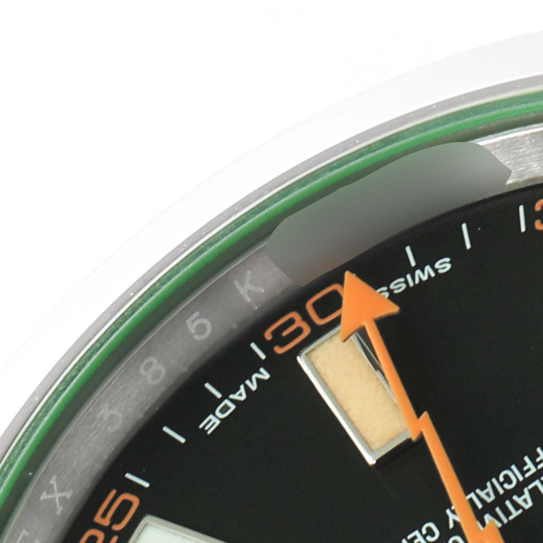 This close-up image of the Rolex Milgauss 116400GV Men's Stainless Steel Black Dial 116400GV Men's Stainless Steel Black Dial watch shows the dial, orange seconds hand, and partial numbers on the chapter ring.
