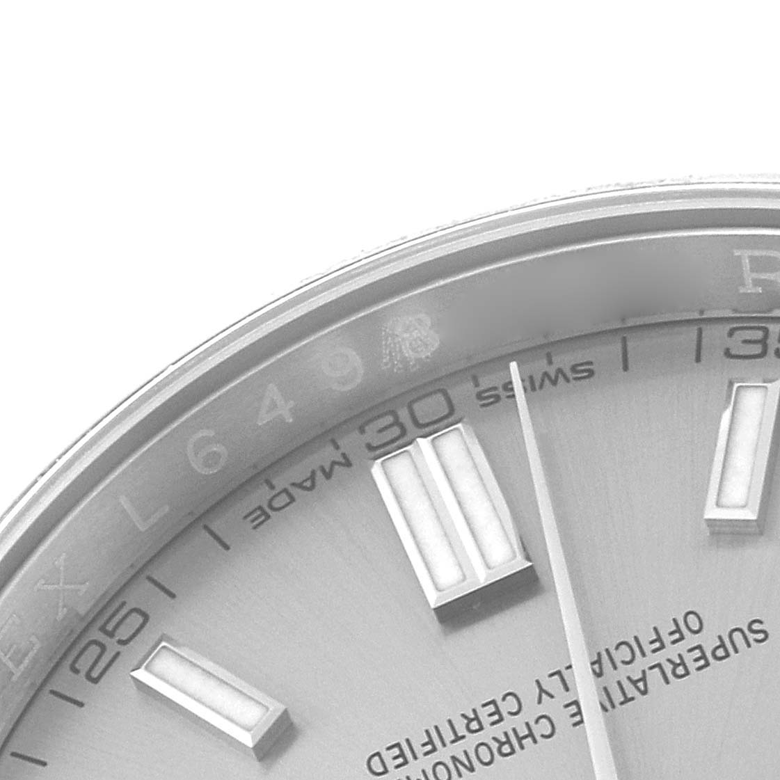 The image shows a close-up of the dial and bezel edge of a Rolex Oyster Perpetual 116000 Men's Stainless Steel Grey Dial 116000 Men's Stainless Steel Grey Dial watch, highlighting the hour markers and minute details.