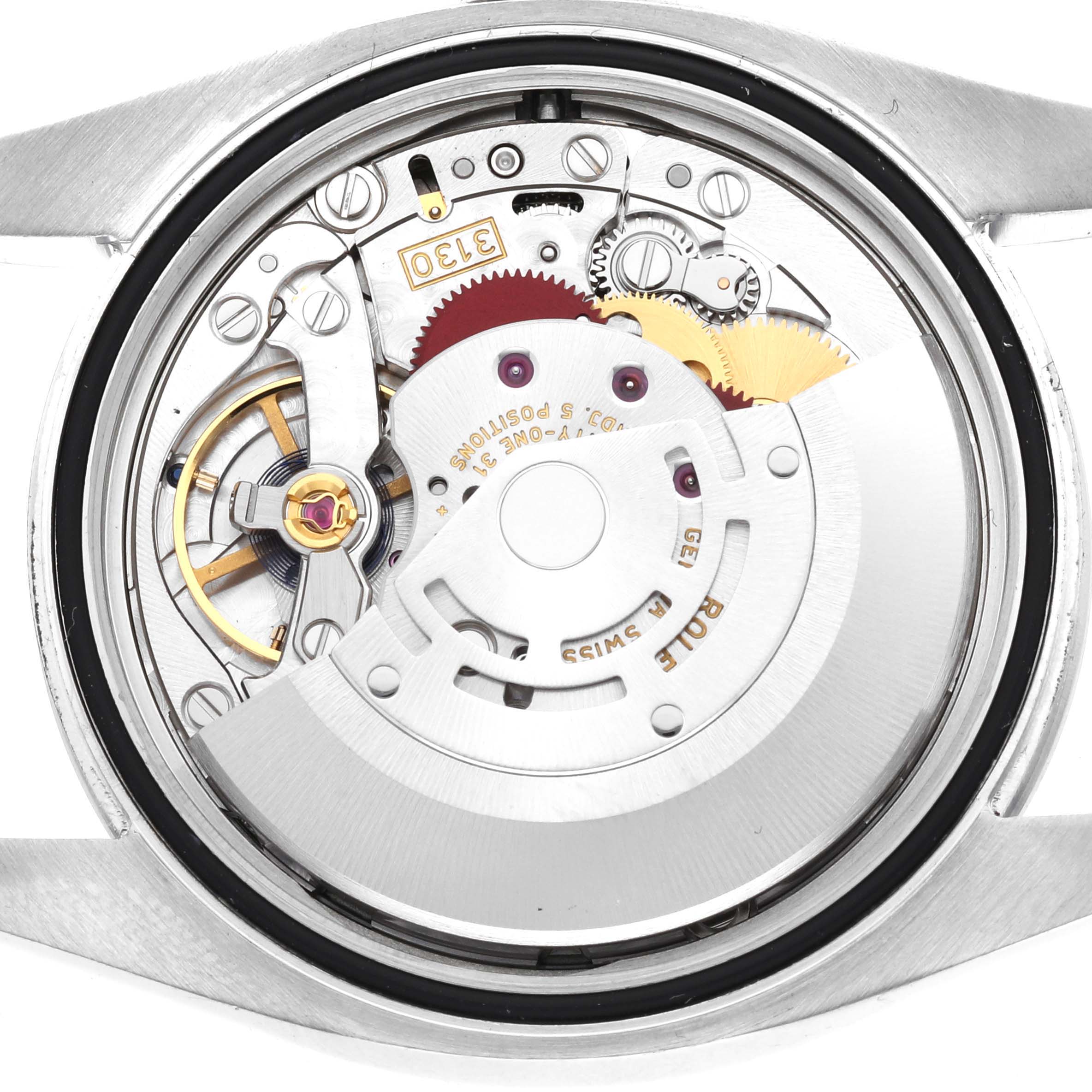 The image shows the intricate inner mechanism of the Rolex Oyster Perpetual 116000 Men's Stainless Steel Grey Dial 116000 Men's Stainless Steel Grey Dial watch from a back view angle.