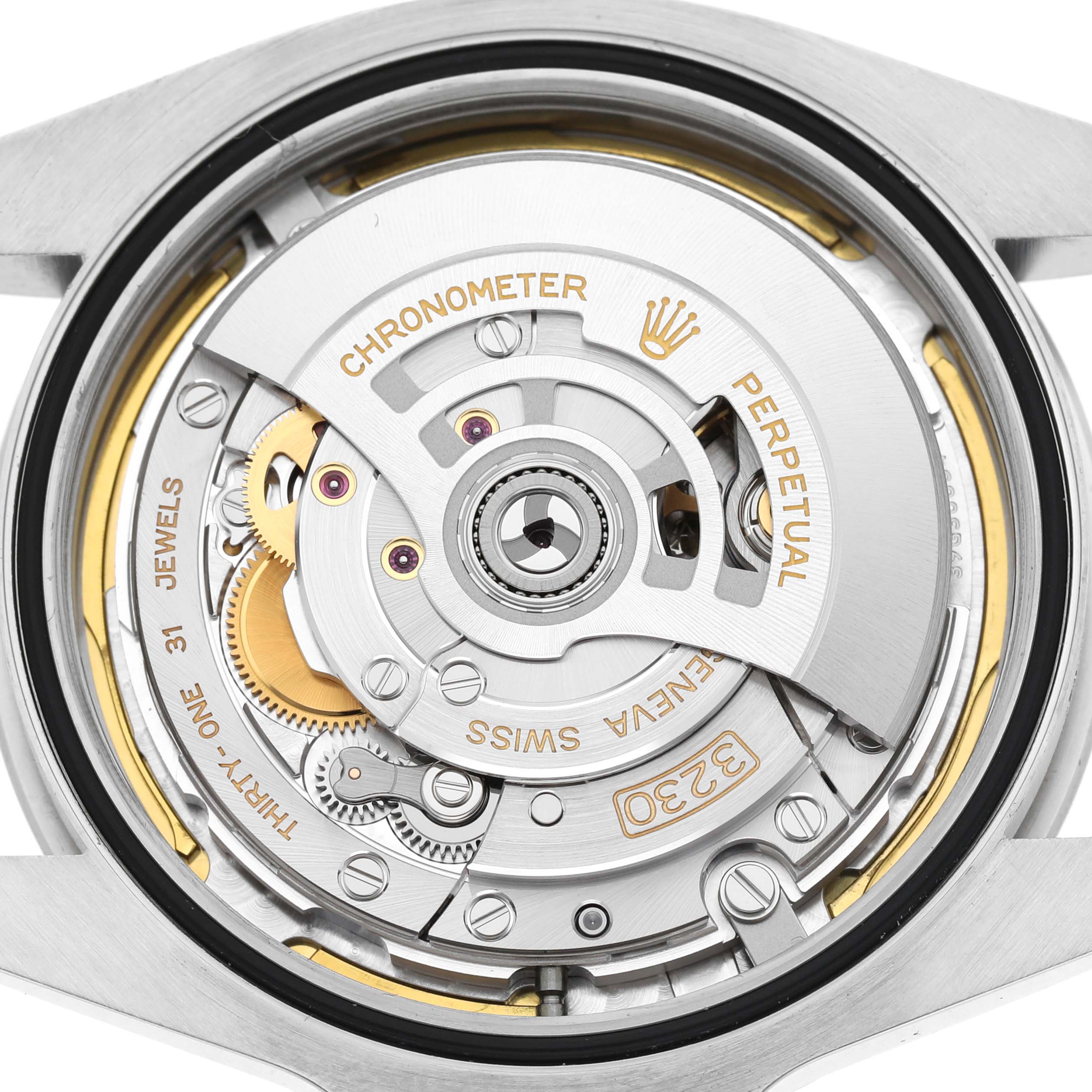 The image shows the movement of a Rolex Air-King 126900 Men's Stainless Steel Black Dial watch, highlighting the rotor and intricate gear details.