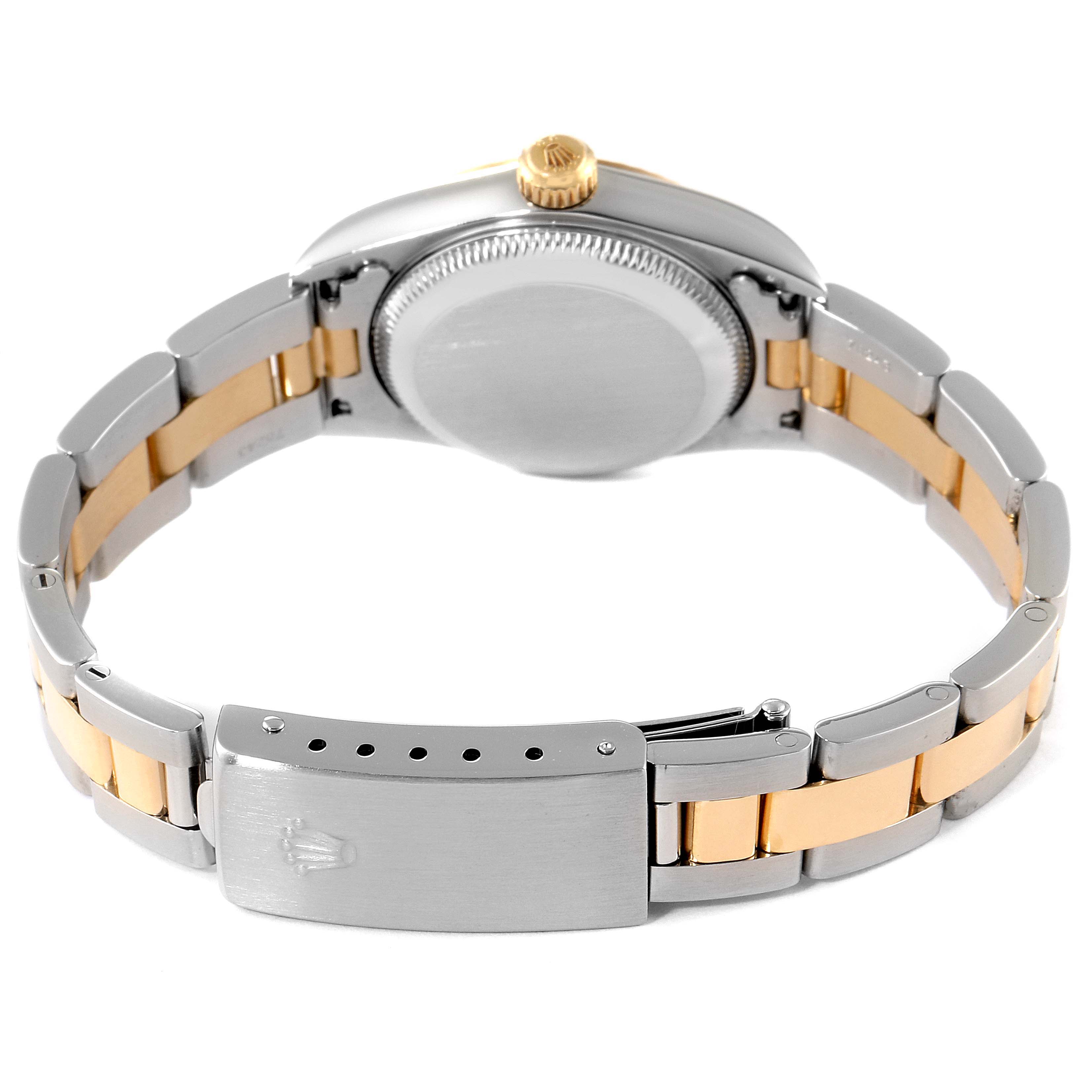 The image shows the back view of a Rolex Oyster Perpetual 76193 Women's Steel and Gold (two tone) Grey Dial 76193 Women's Steel and Gold (two tone) Grey Dial watch, highlighting its case, crown, and bicolor bracelet with clasp.