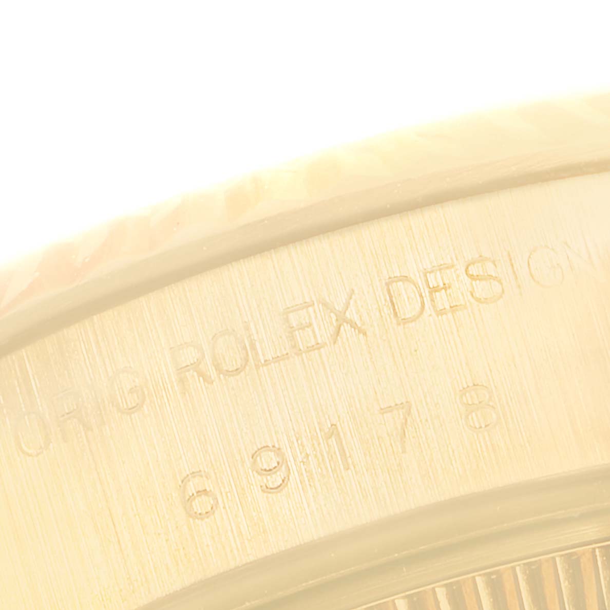 The image shows a close-up of the engraved side of a Rolex President 69178 Women
s Yellow Gold Champagne Dial 69178 Women
s Yellow Gold Champagne Dial watch, highlighting the branding and model number.
