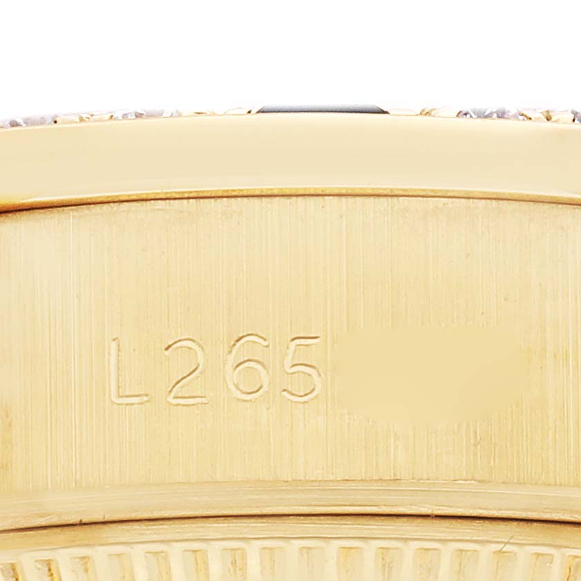 The image shows a close-up of the side of a Rolex President 69088 Women
s Yellow Gold Champagne Dial 69088 Women
s Yellow Gold Champagne Dial model watch, focusing on the serial number and case edge.