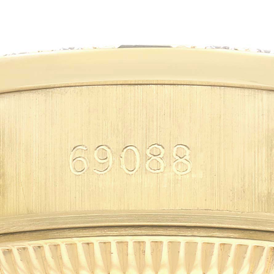The image shows a close-up side view of the case of a Rolex President 69088 Women
s Yellow Gold Champagne Dial 69088 Women
s Yellow Gold Champagne Dial watch with a visible model number engraved.