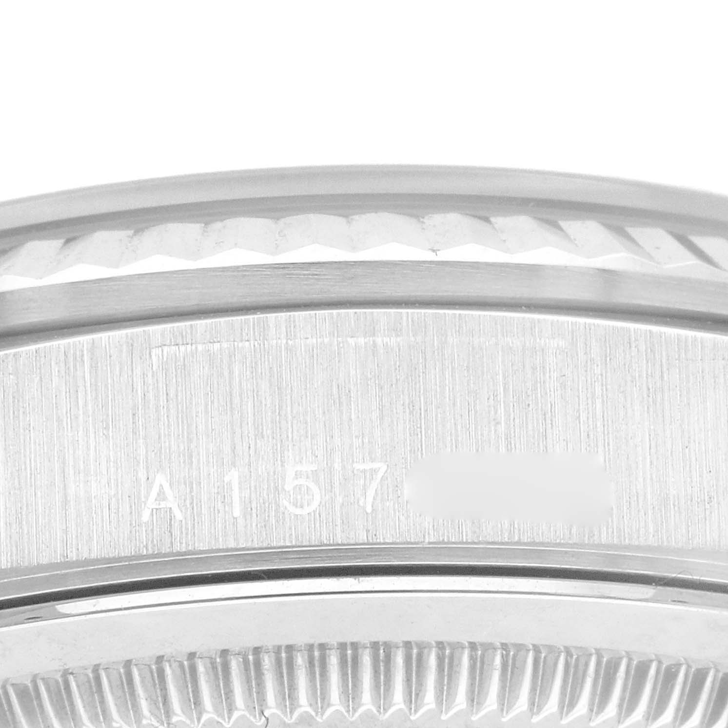 This close-up image shows the side and some engravings on the bezel and case of a Rolex President 18239A Men
s White Gold Blue Dial 18239A Men
s White Gold Blue Dial model watch.
