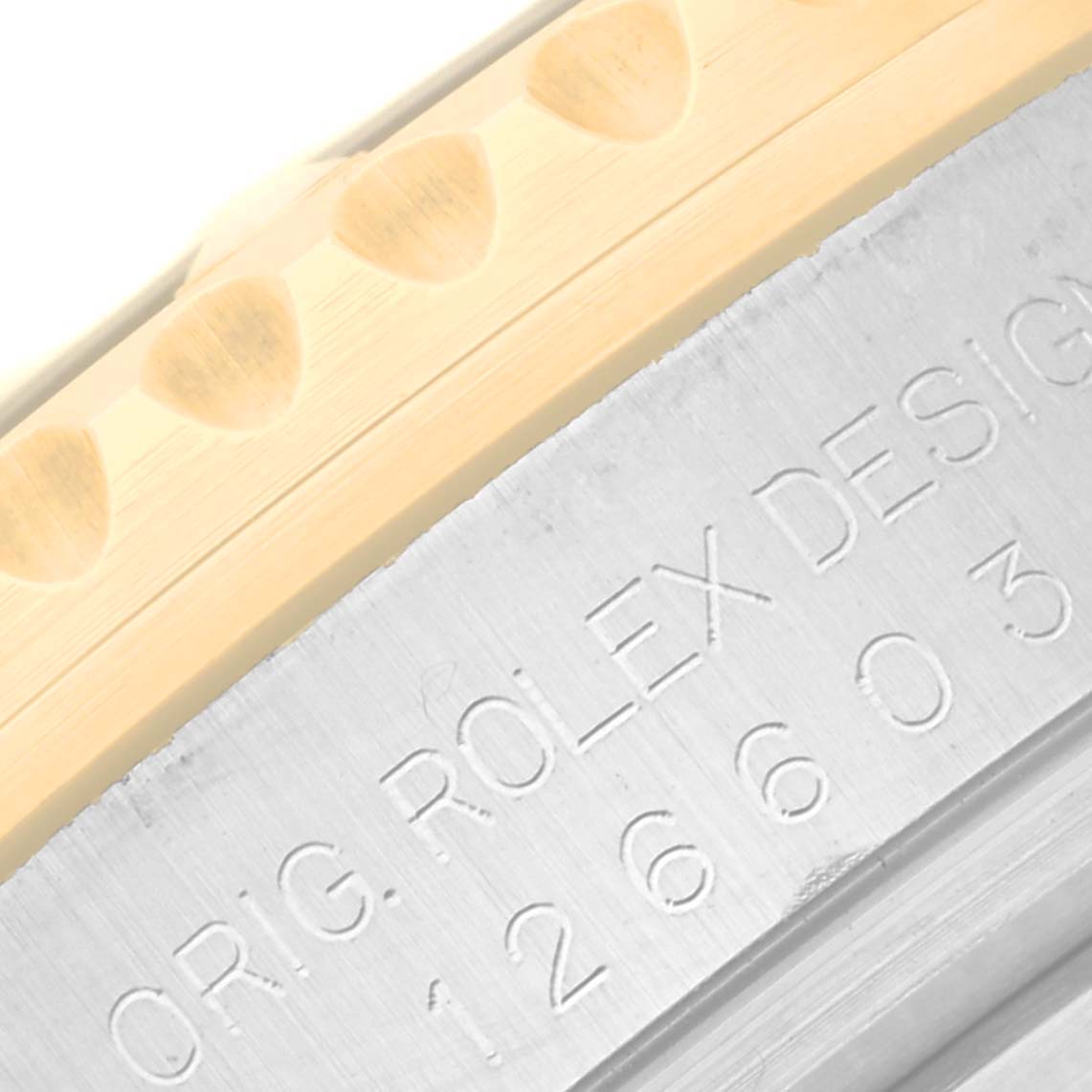 This close-up shot of a Rolex Sea-Dweller 126603 Men's Steel and Gold (two tone) Black Dial 126603 Men's Steel and Gold (two tone) Black Dial shows part of the bezel and engraved model number on the case.