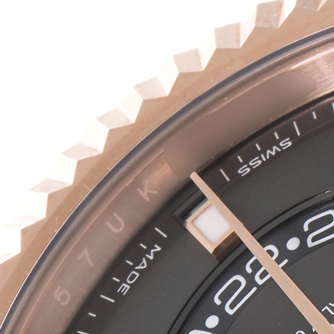 This close-up shot of a Rolex Sky-Dweller 326235 Men's Rose Gold Grey Dial 326235 Men's Rose Gold Grey Dial watch shows part of the bezel, dial, and hour hand.