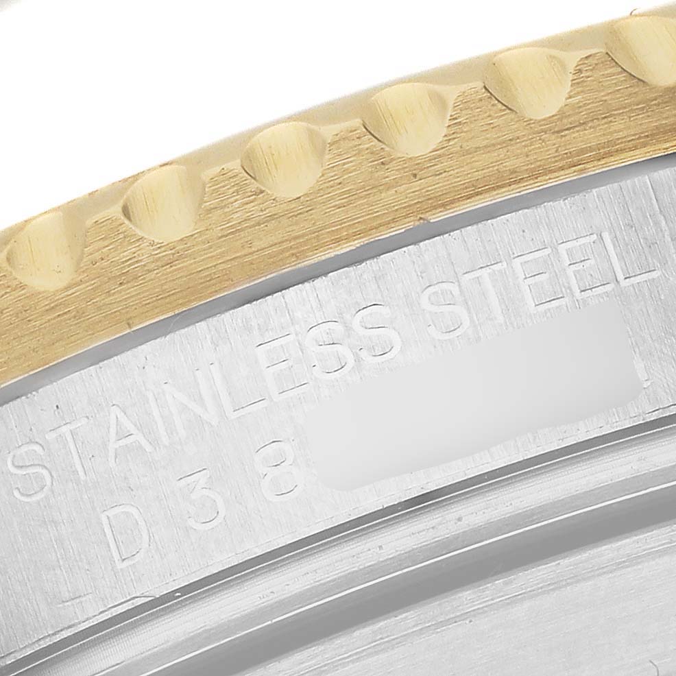 The image shows a close-up of the Rolex Submariner 16613 Men's Steel and Gold (two tone) Champagne Dial's stainless steel case back with part of the gold bezel.