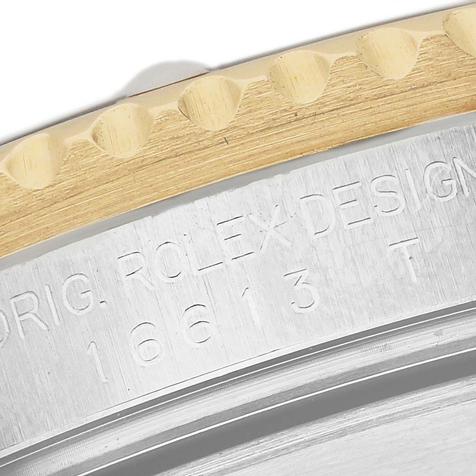 The image shows a close-up of the bezel and engraved case side of a Rolex Submariner 16613 Men's Steel and Gold (two tone) Champagne Dial watch.