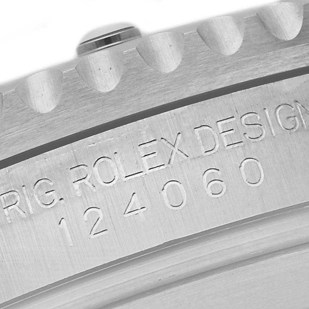 This image shows a close-up of the engraved model number and bezel teeth of a Rolex Submariner 124060 Men's Stainless Steel Black Dial 124060 Men's Stainless Steel Black Dial.