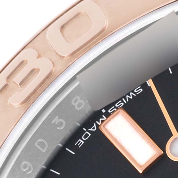The image shows a close-up of the bezel and part of the dial of a Rolex Yacht-Master 116621 Men's Steel and Gold (two tone) Black Dial 116621 Men's Steel and Gold (two tone) Black Dial watch, including some hour markers and the "Swiss Made" text.