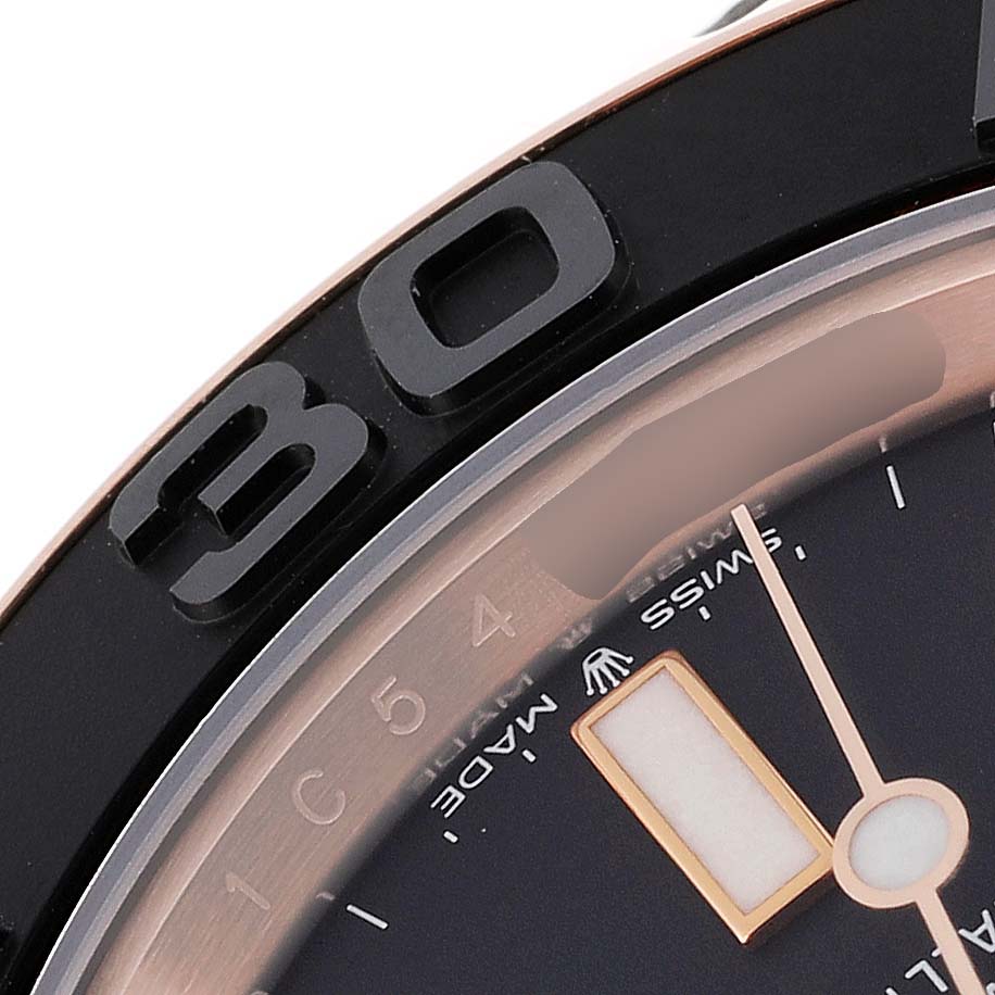 The image shows a close-up of the bezel and part of the dial of a Rolex Yacht-Master 126655 Men's Rose Gold Black Dial 126655 Men's Rose Gold Black Dial watch.