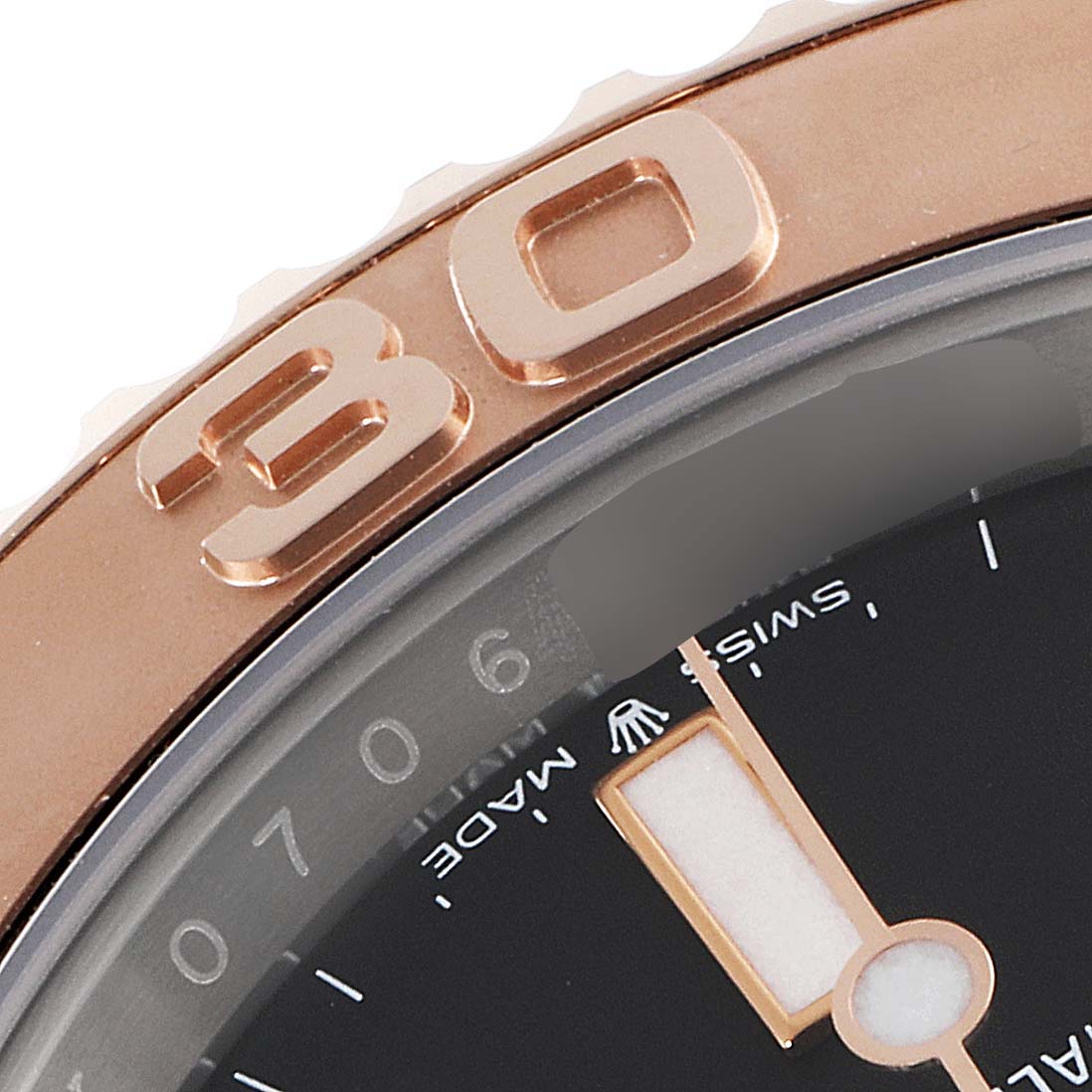 This image shows a close-up of the bezel and part of the dial of a Rolex Yacht-Master 126621 Men's Steel and Gold (two tone) Black Dial 126621 Men's Steel and Gold (two tone) Black Dial watch.