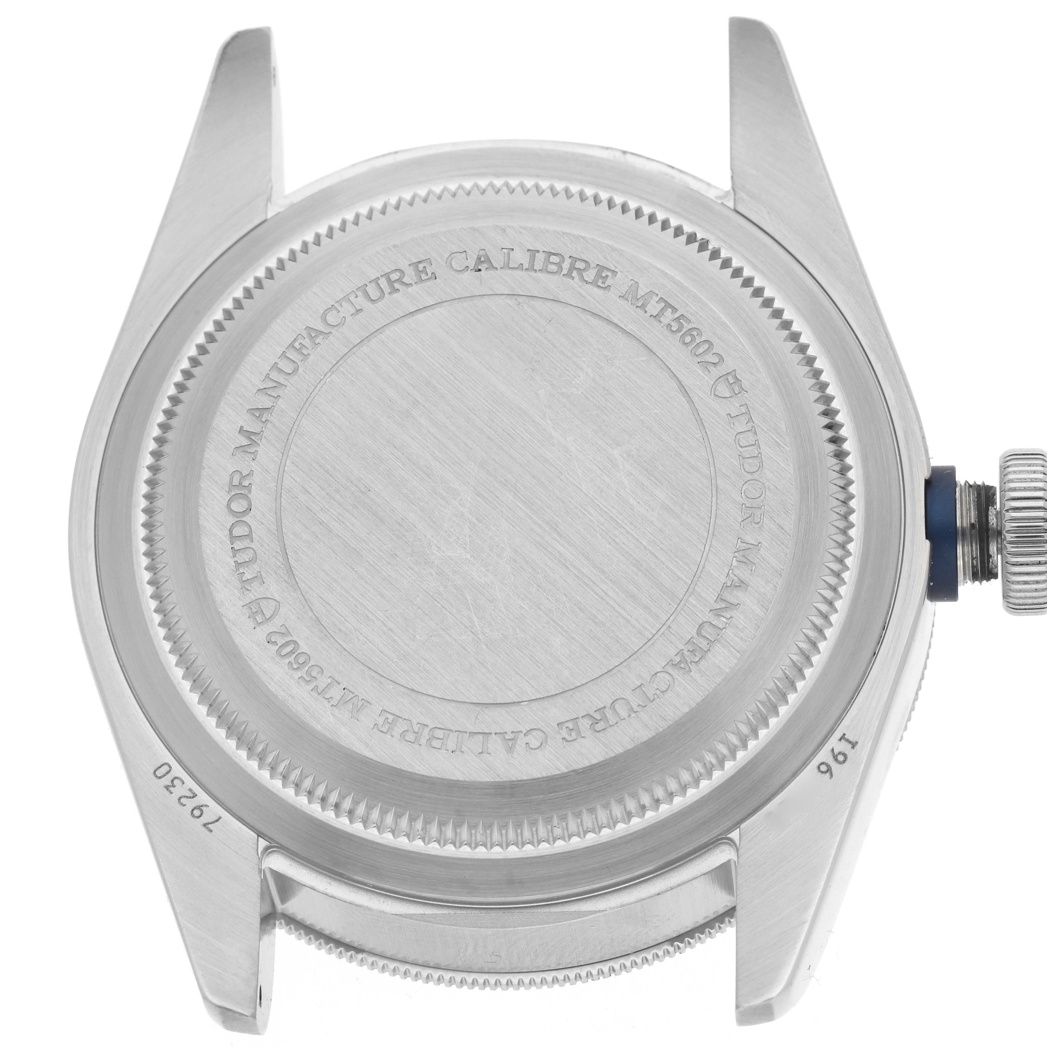 The image shows the back case and crown of a Tudor Heritage Black Bay 79230B Men
s Stainless Steel Black Dial 79230B Men
s Stainless Steel Black Dial watch.