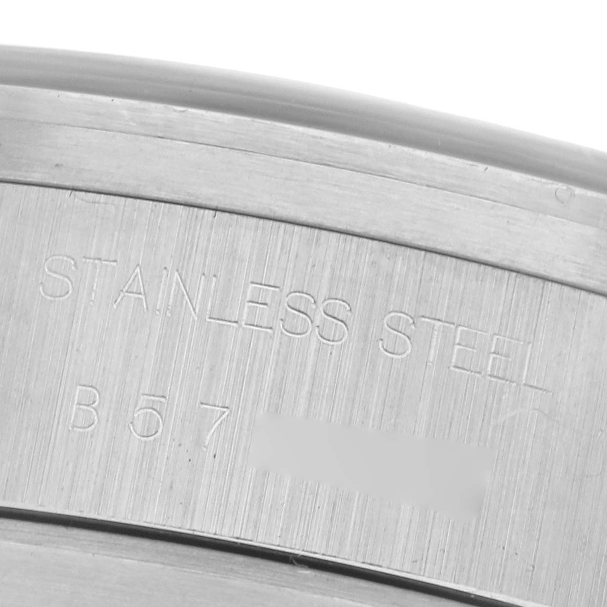 This image shows an engraved stainless steel case, part of the Tudor Prince 79180 Men
s Stainless Steel Black Dial 79180 Men
s Stainless Steel Black Dial watch, with a close-up angle displaying serial markings.