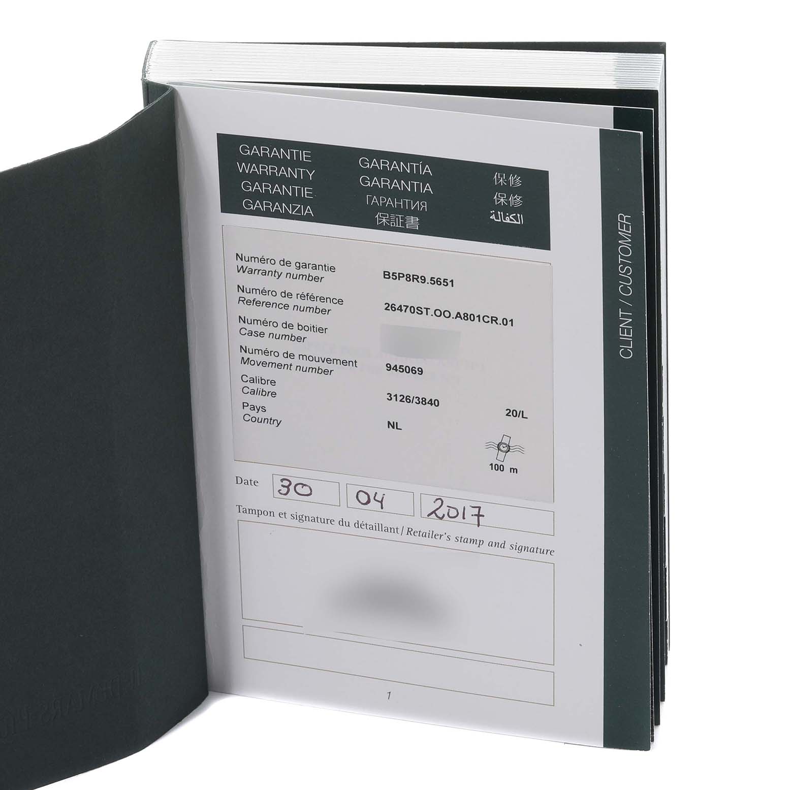 This image shows an open warranty book for the Audemars Piguet Royal Oak Offshore 26470ST.OO.A801CR.01 Men's Stainless Steel Silver Dial 26470ST.OO.A801CR.01 Men's Stainless Steel Silver Dial model.