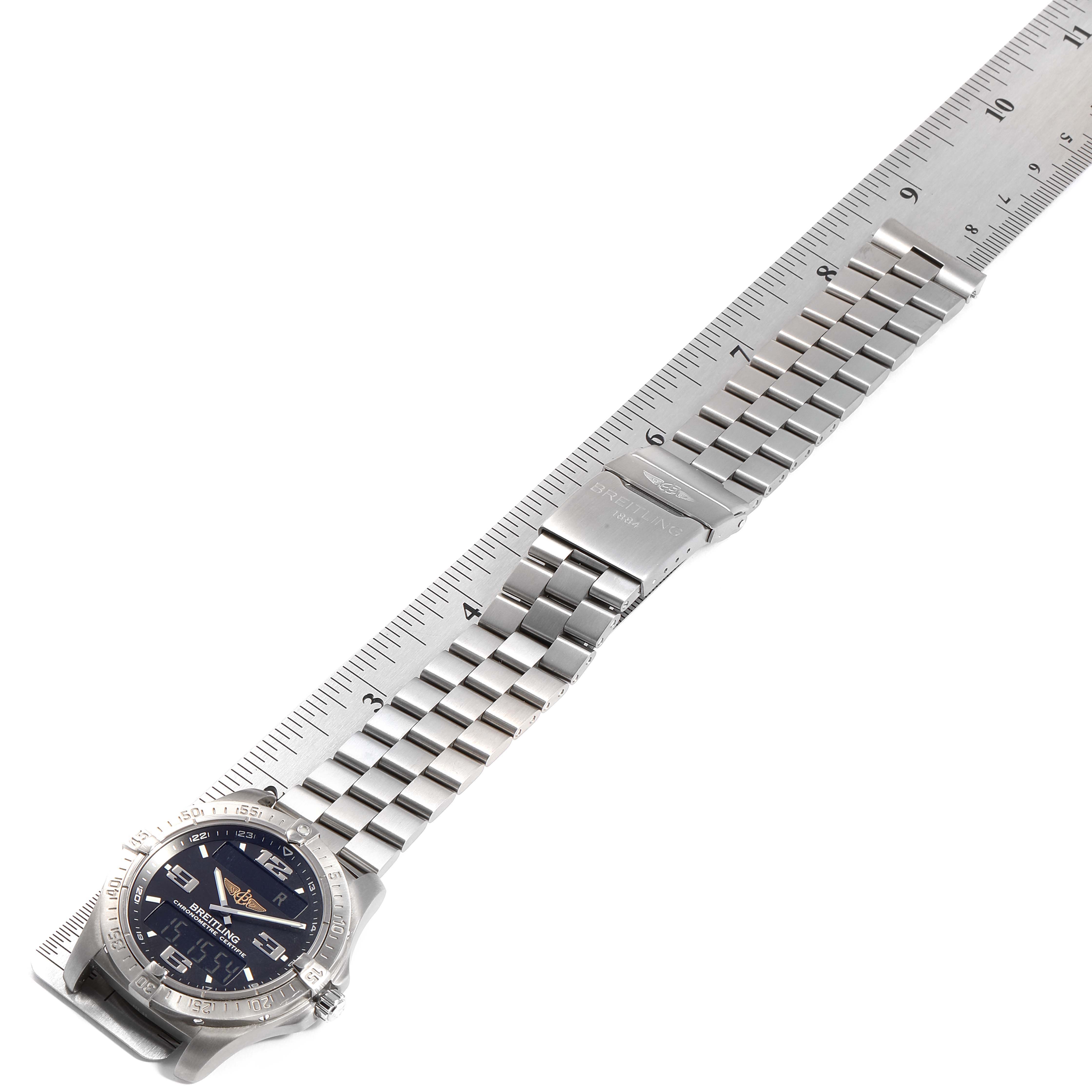 The Breitling Superocean E7936210 Men's Titanium Grey Dial E7936210 Men's Titanium Grey Dial watch is shown in a laid-flat position with a focus on the stainless steel bracelet and clasp, alongside a ruler.
