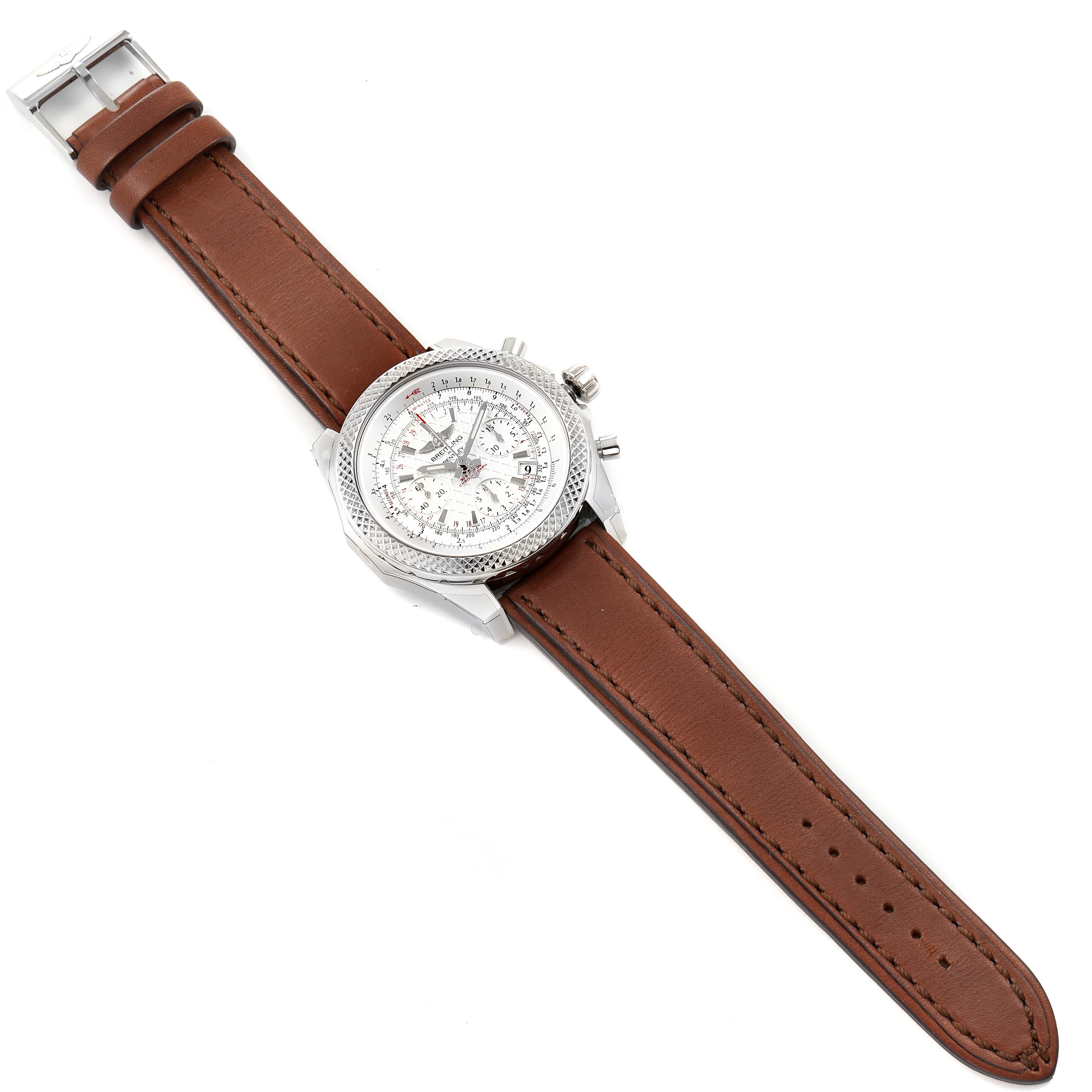 The Bentley model by Breitling is shown from a top-down angle, displaying the brown leather strap and detailed watch face.