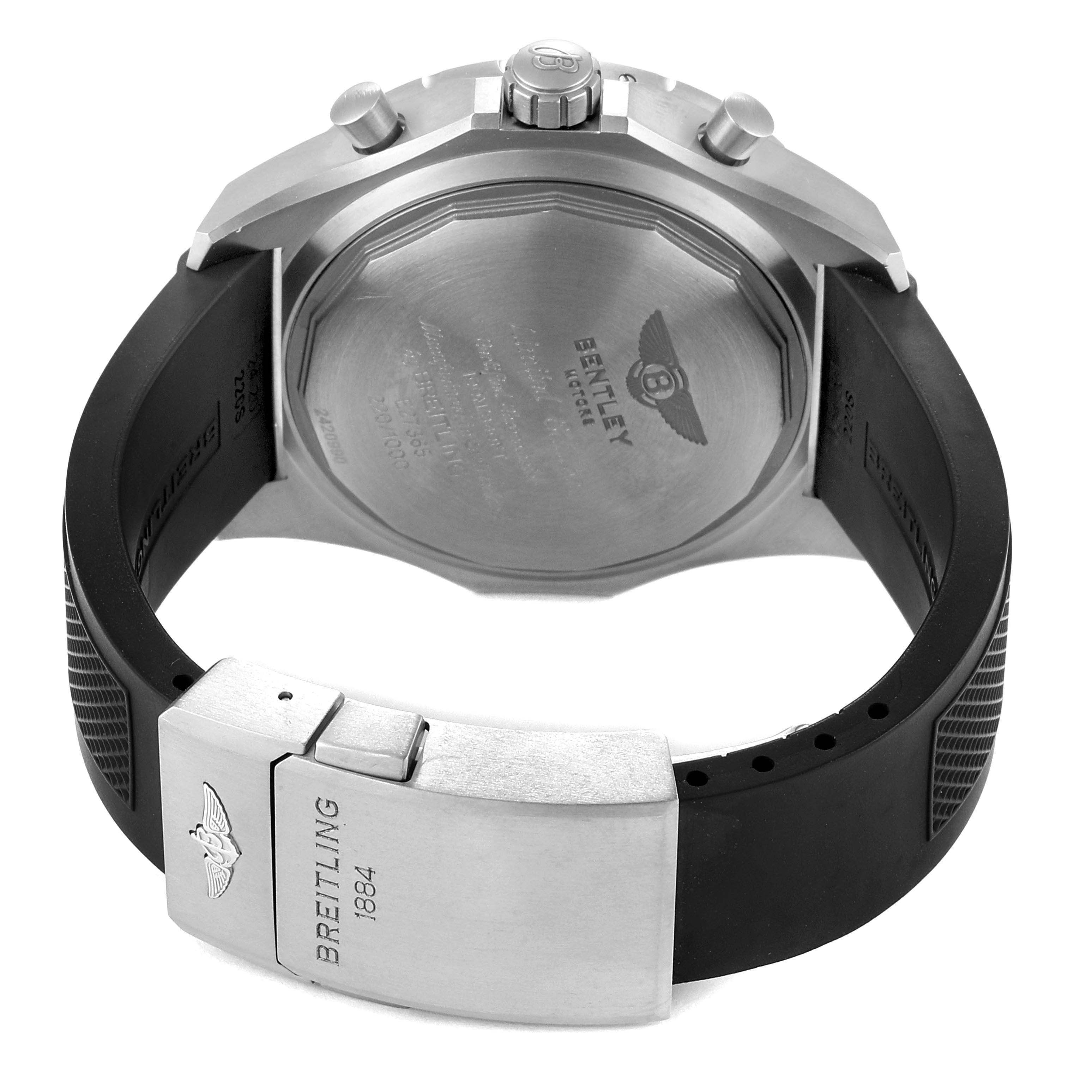 The image shows the back view of a Breitling Bentley E27365 Men's Titanium Black Dial E27365 Men's Titanium Black Dial model watch, displaying the case back, crown, pushers, and rubber strap with a clasp.