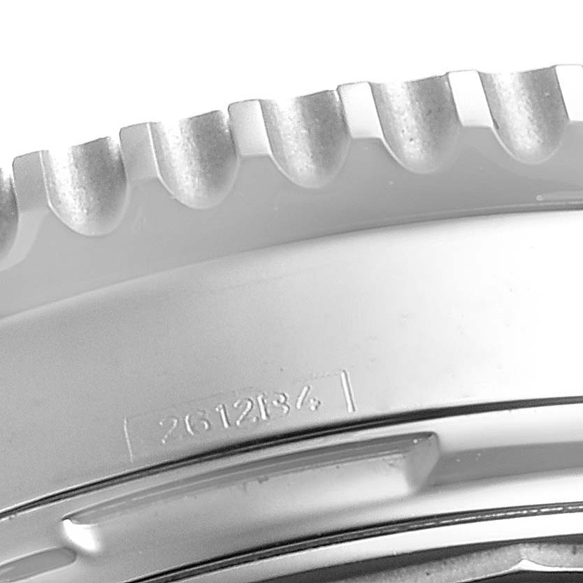 The image shows a close-up of the bezel and part of the casing of a Breitling Navitimer AB0123 Men's Stainless Steel Silver Dial AB0123 Men's Stainless Steel Silver Dial watch.