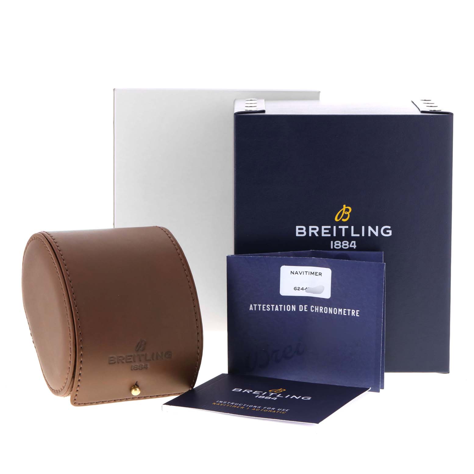 The image shows a Breitling Navitimer U17325211G1A1 Men
s Stainless Steel Silver Dial U17325211G1A1 Men
s Stainless Steel Silver Dial watch packaging, including a leather case, instruction manual, and branded boxes.