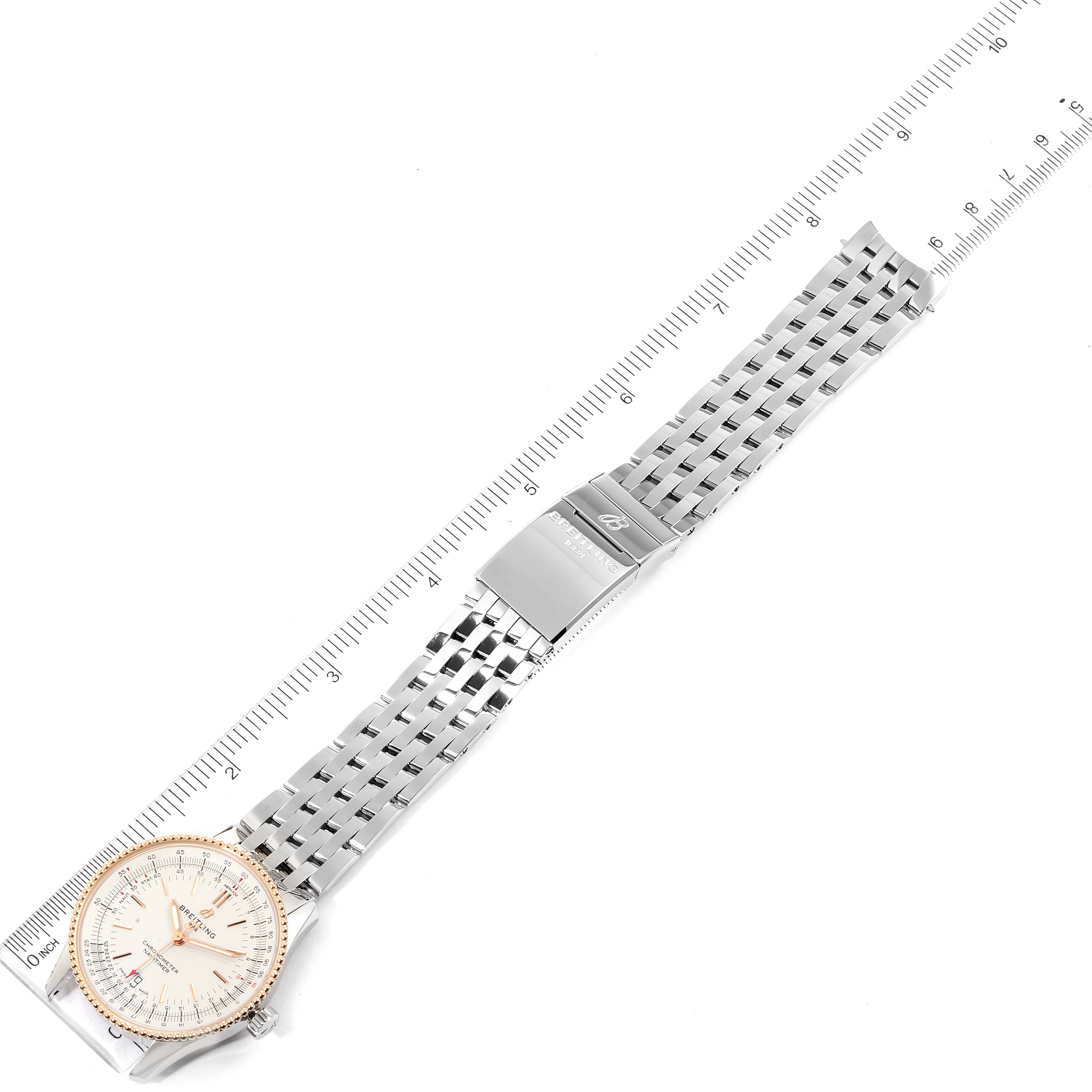 The image shows a top-down view of a Breitling Navitimer U17325211G1A1 Men
s Stainless Steel Silver Dial U17325211G1A1 Men
s Stainless Steel Silver Dial watch, including its face, bracelet, and clasp.