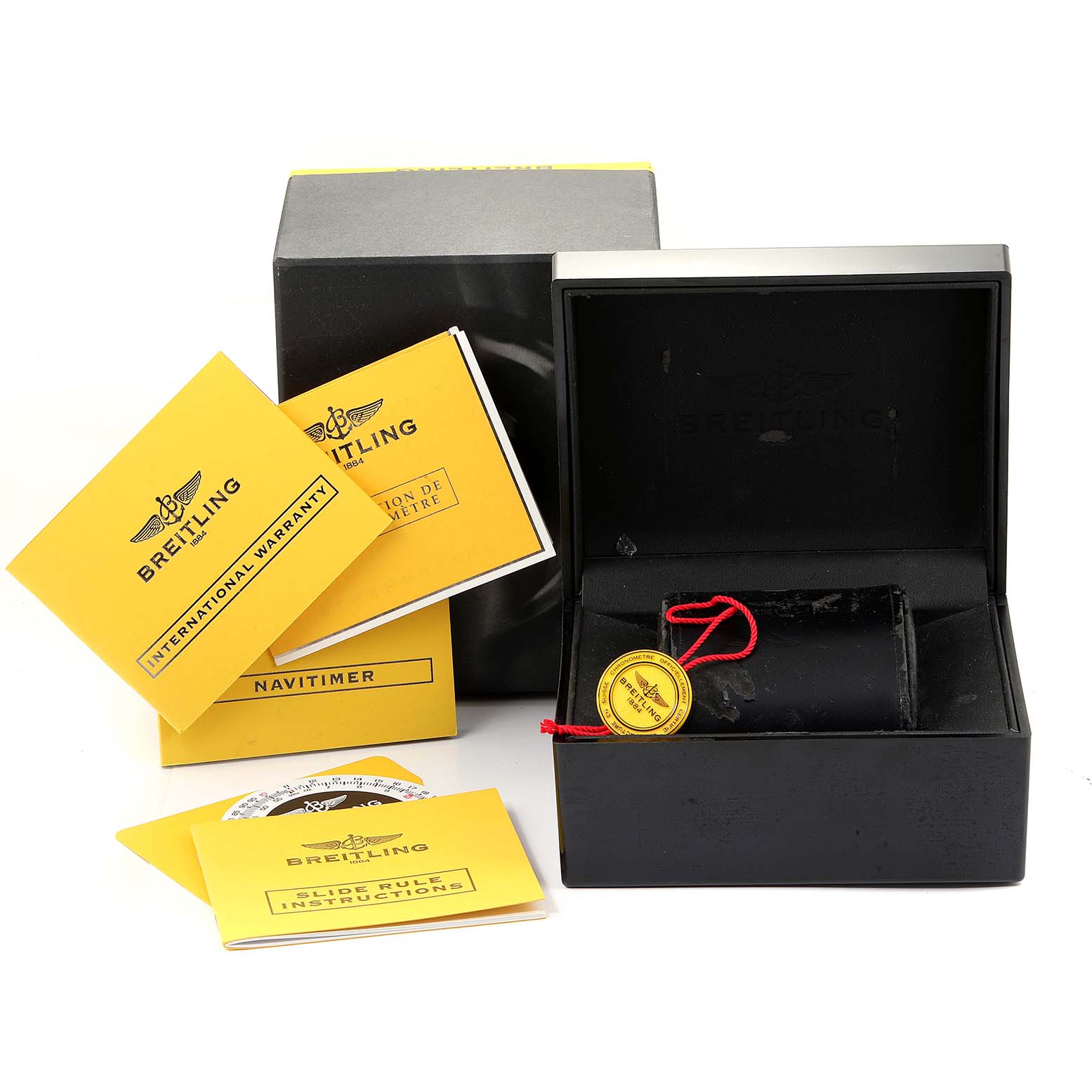The image shows the Breitling Navitimer A23322 Men
s Stainless Steel Black Dial A23322 Men
s Stainless Steel Black Dial watch packaging, including the box, tags, and various manuals.
