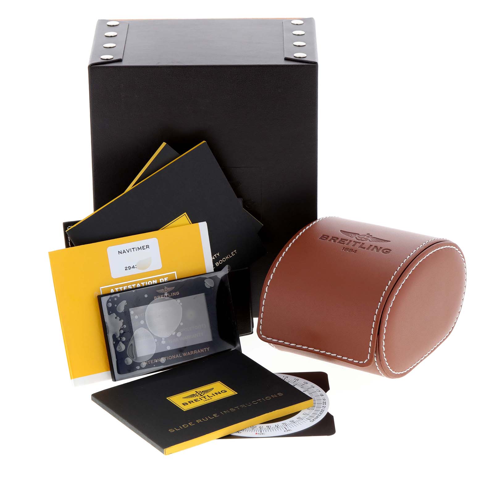 The image shows accessories for a Breitling Navitimer A24322 Men's Stainless Steel Blue Dial A24322 Men's Stainless Steel Blue Dial watch, including a box, leather pouch, manuals, warranty card, and slide rule instructions.