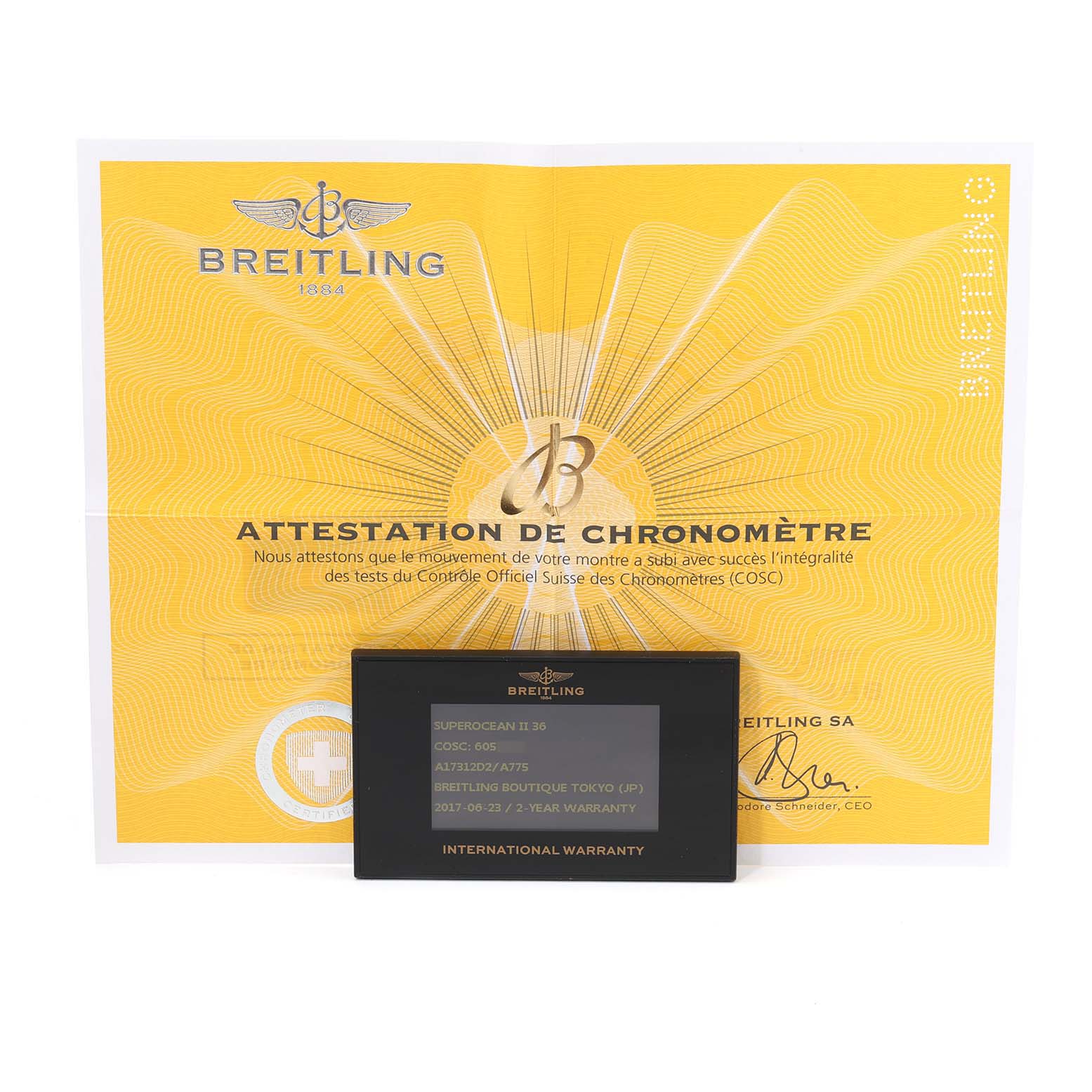 The image shows warranty papers and a certificate for a Breitling A17312 Women's Stainless Steel White Dial A17312 Women's Stainless Steel White Dial Superocean II Hurricane 36 Ladies Watch A17312 model.