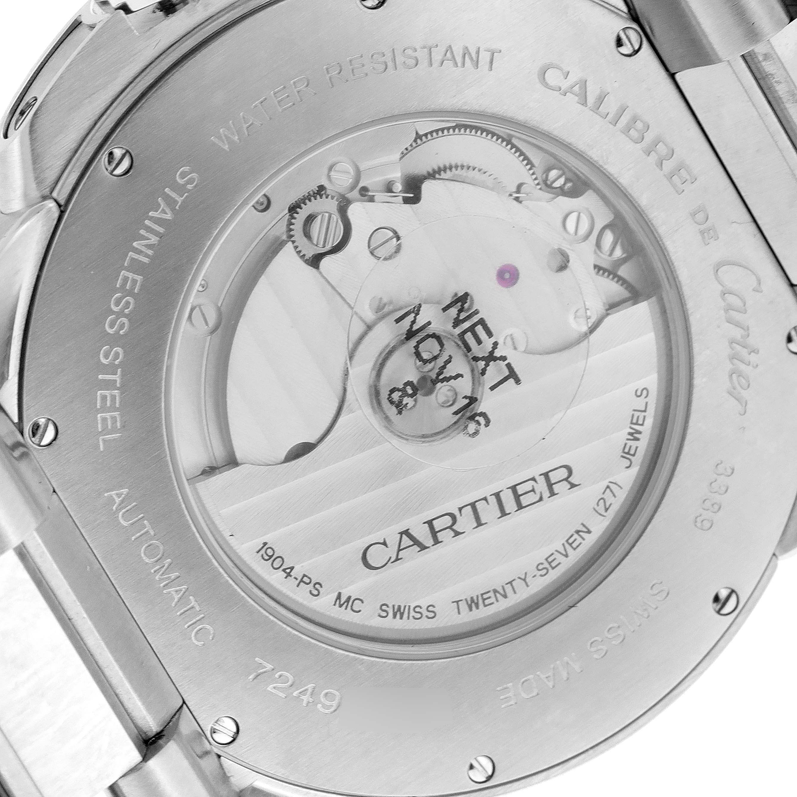 The image shows the back of a Calibre de Cartier watch by Cartier, revealing the movement and engravings.
