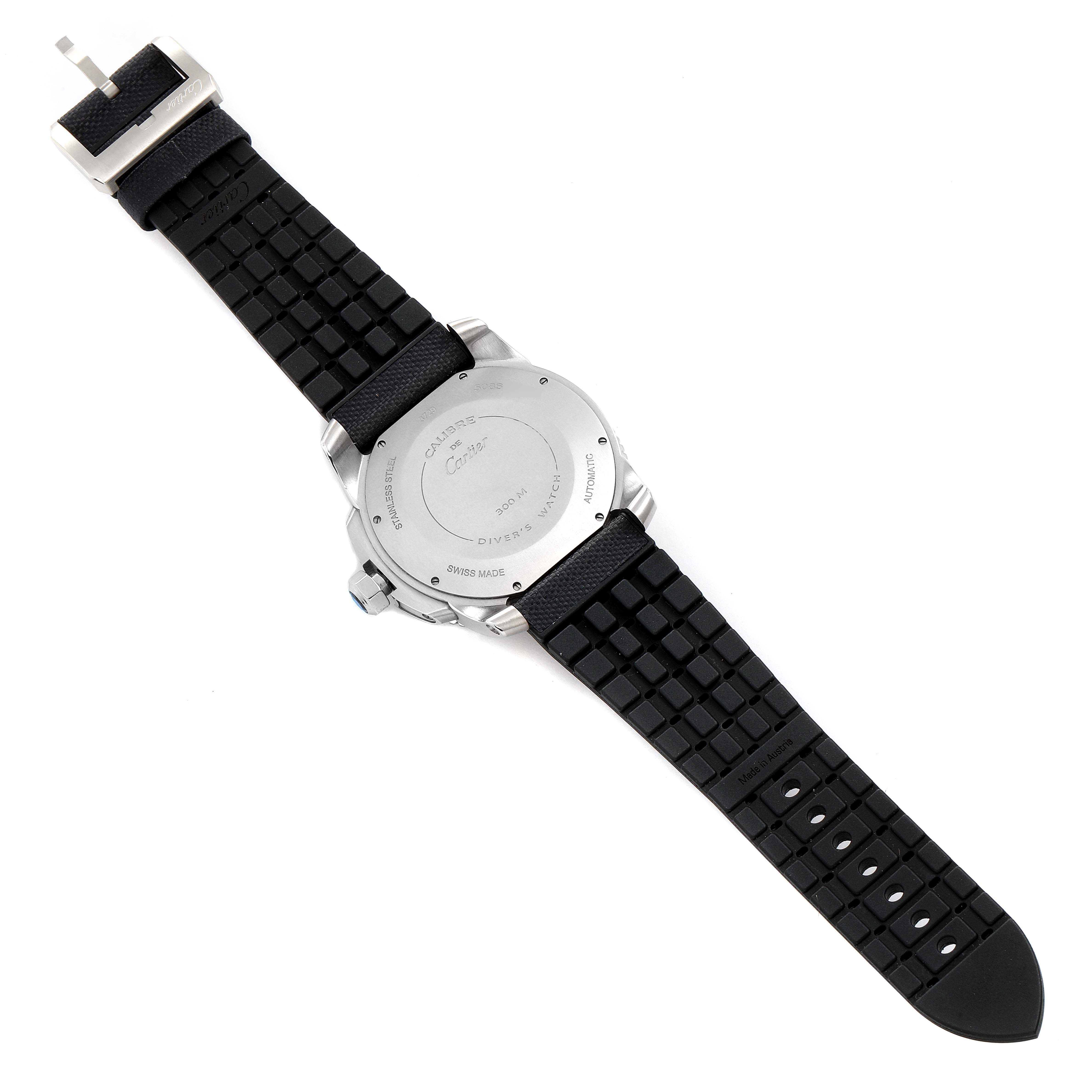 The image shows the back view of a Calibre de Cartier watch by Cartier, highlighting the case back and black rubber strap.