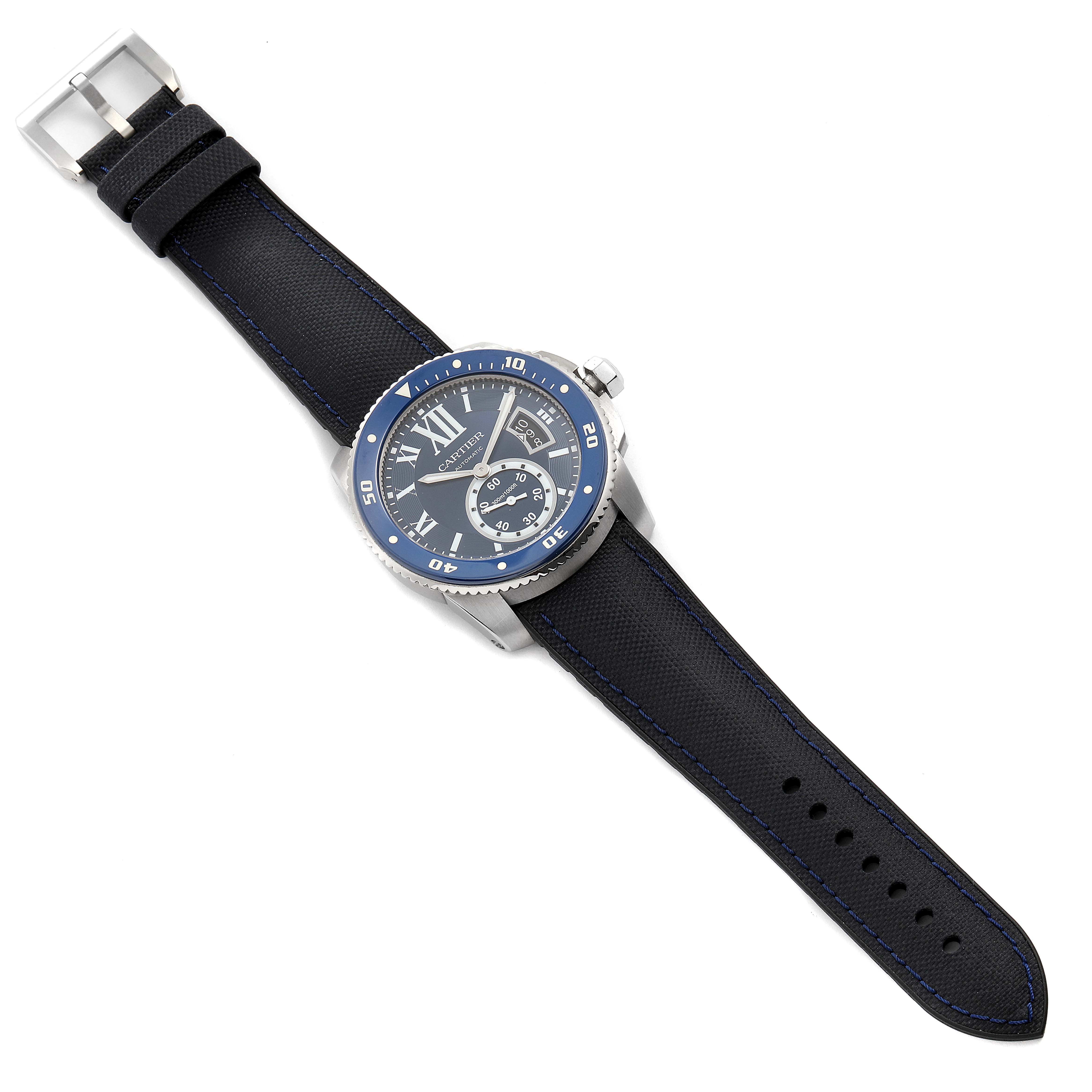 The image shows a Calibre de Cartier watch by Cartier from a top-down angle, displaying the face, bezel, crown, and strap.