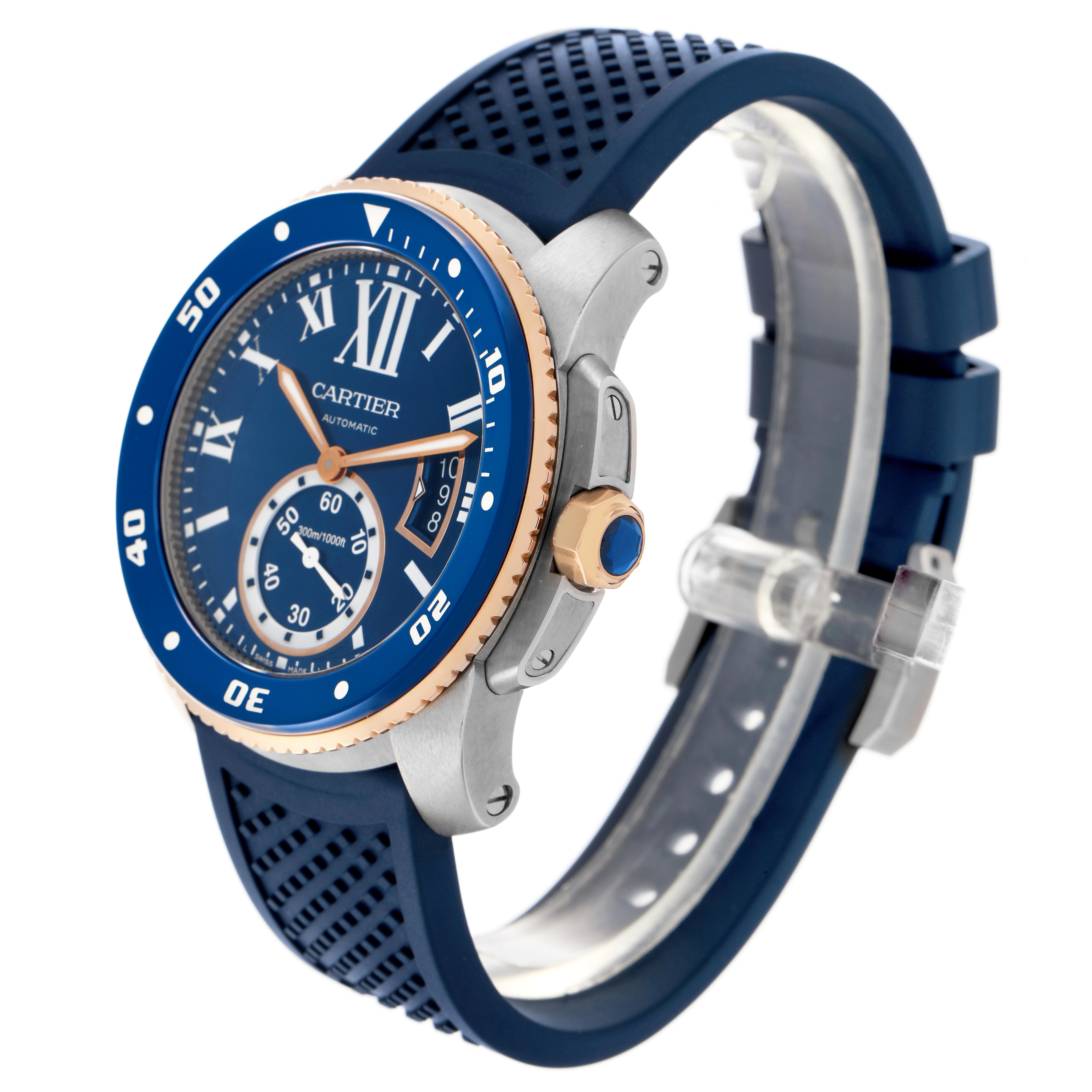 The Calibre de Cartier watch is shown at a three-quarter angle, highlighting the blue dial, bezel, crown, and rubber strap.