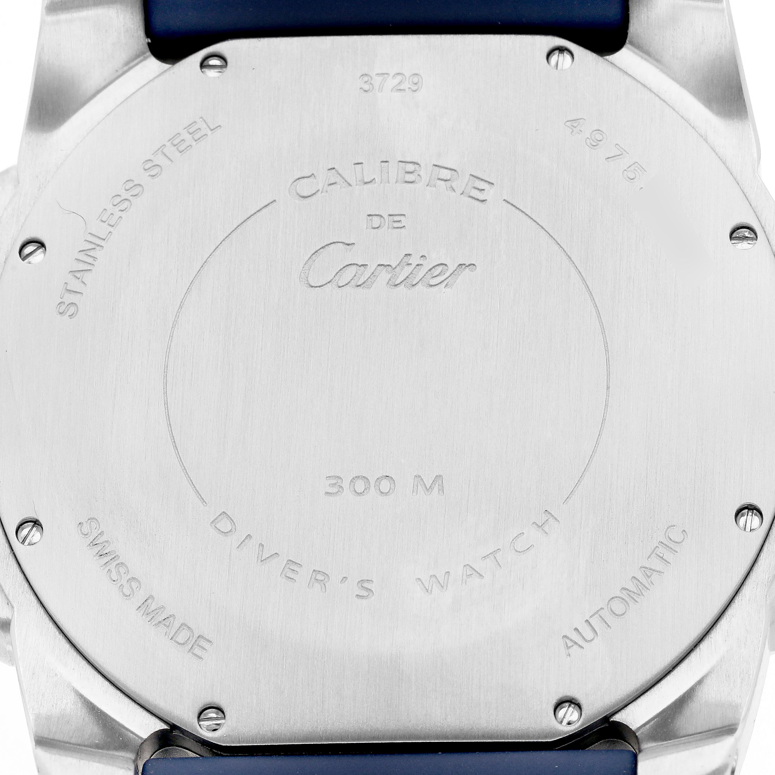 The image shows the back case of the Calibre de Cartier watch by Cartier, highlighting its stainless steel design and markings.