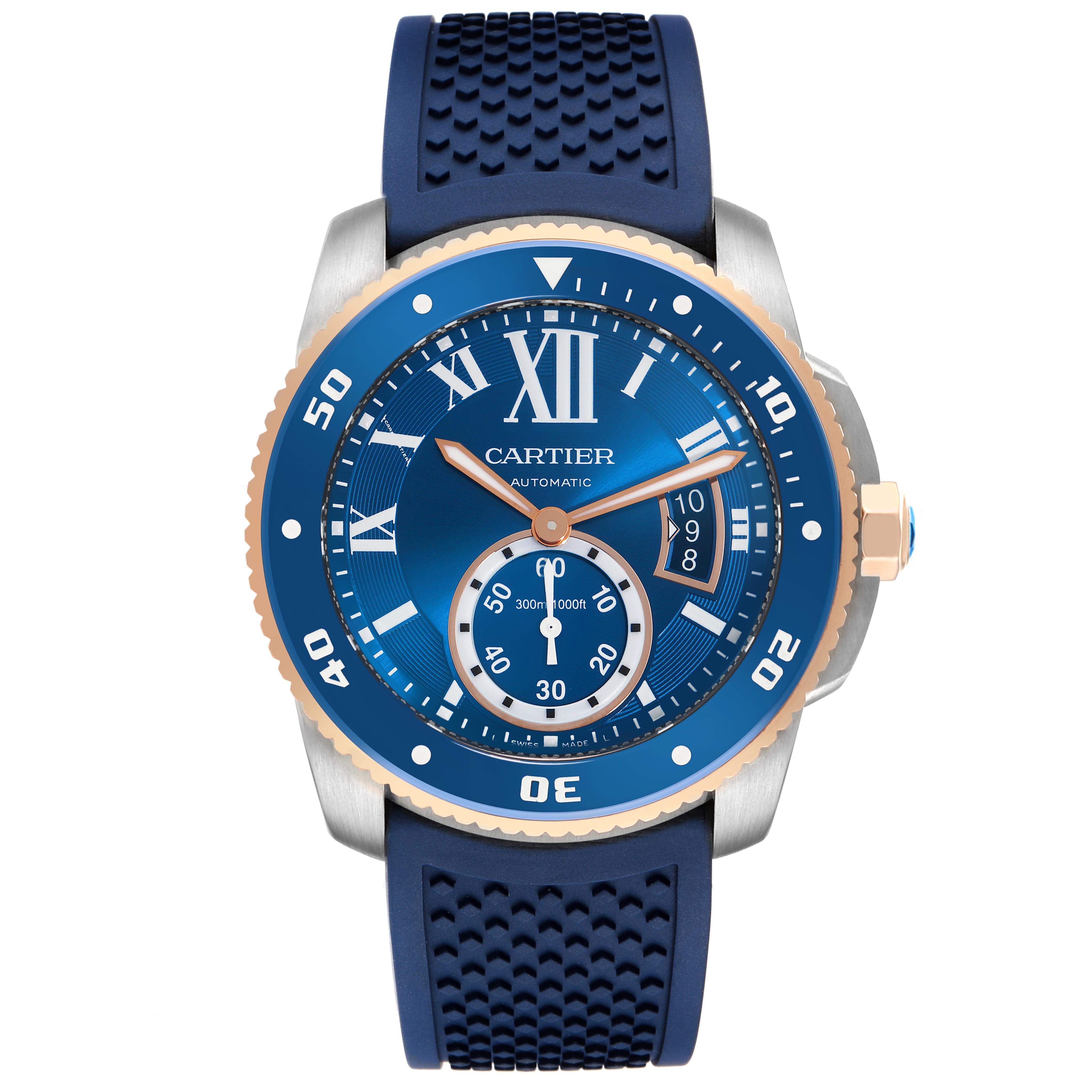 The Calibre de Cartier watch is shown from the front, displaying its blue dial, gold-tone bezel, and textured strap.
