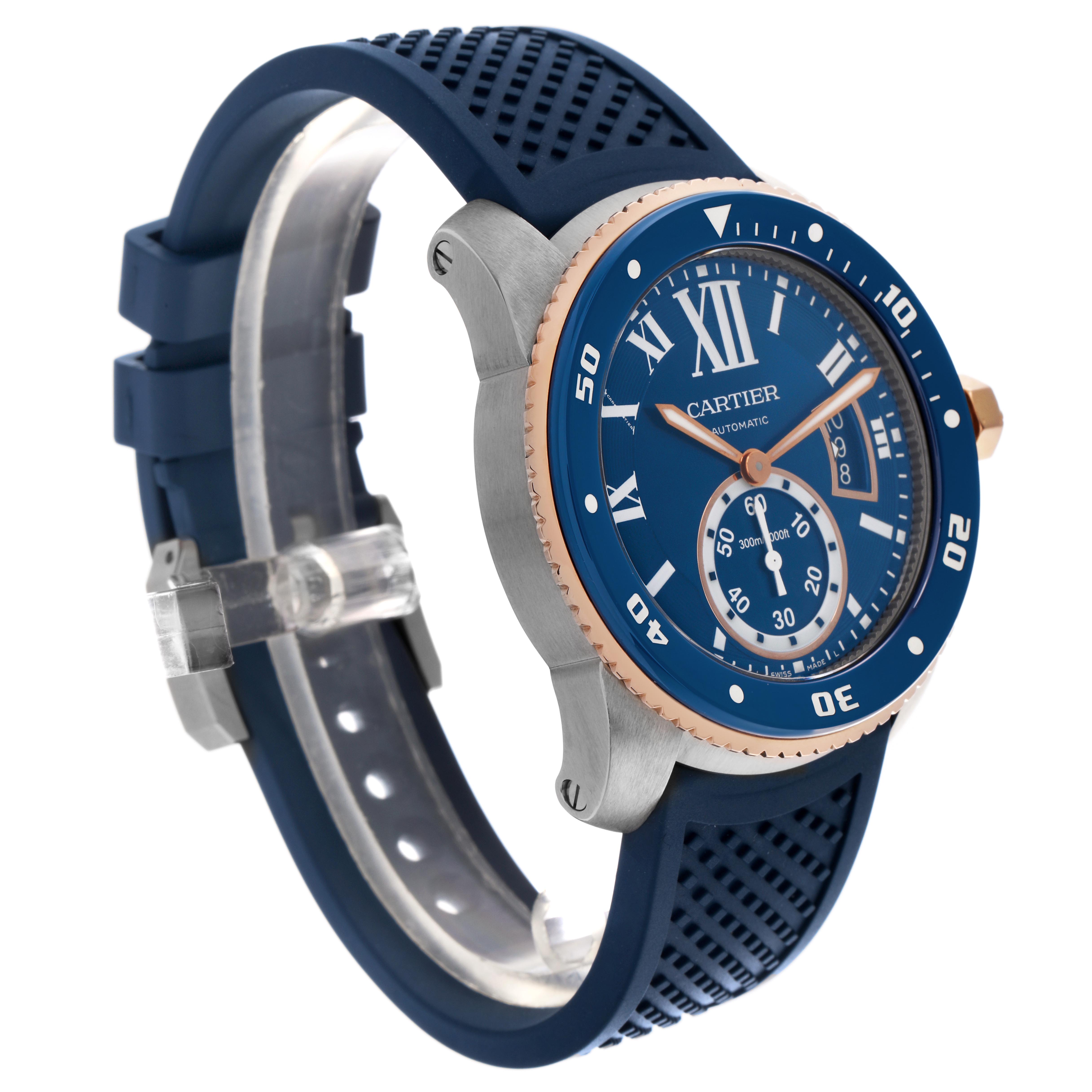 The Calibre de Cartier watch is shown at a three-quarter angle, displaying its blue dial, bezel, and rubber strap.