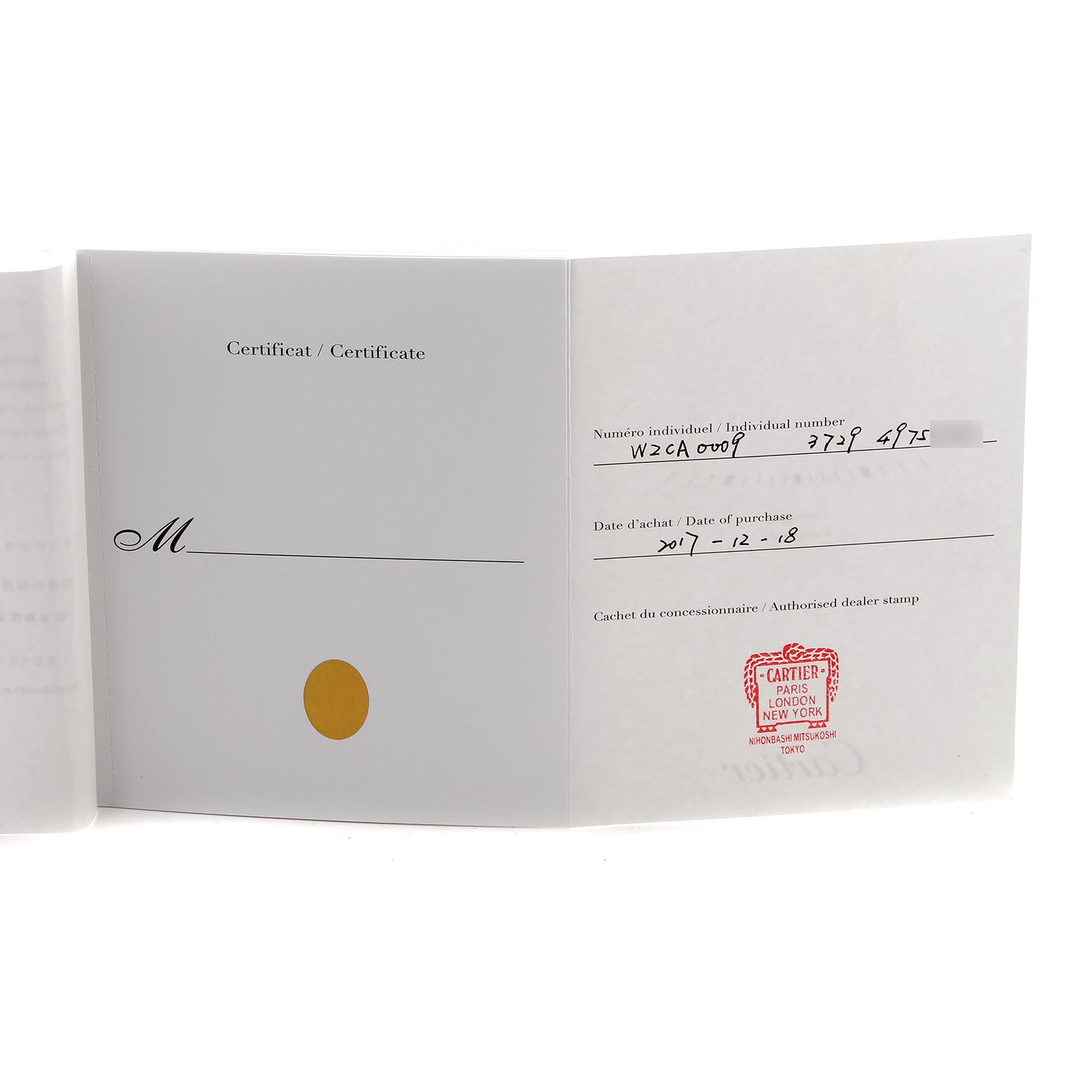 The image shows an open warranty card for a Calibre de Cartier watch by Cartier, displaying the dealer stamp and purchase details.