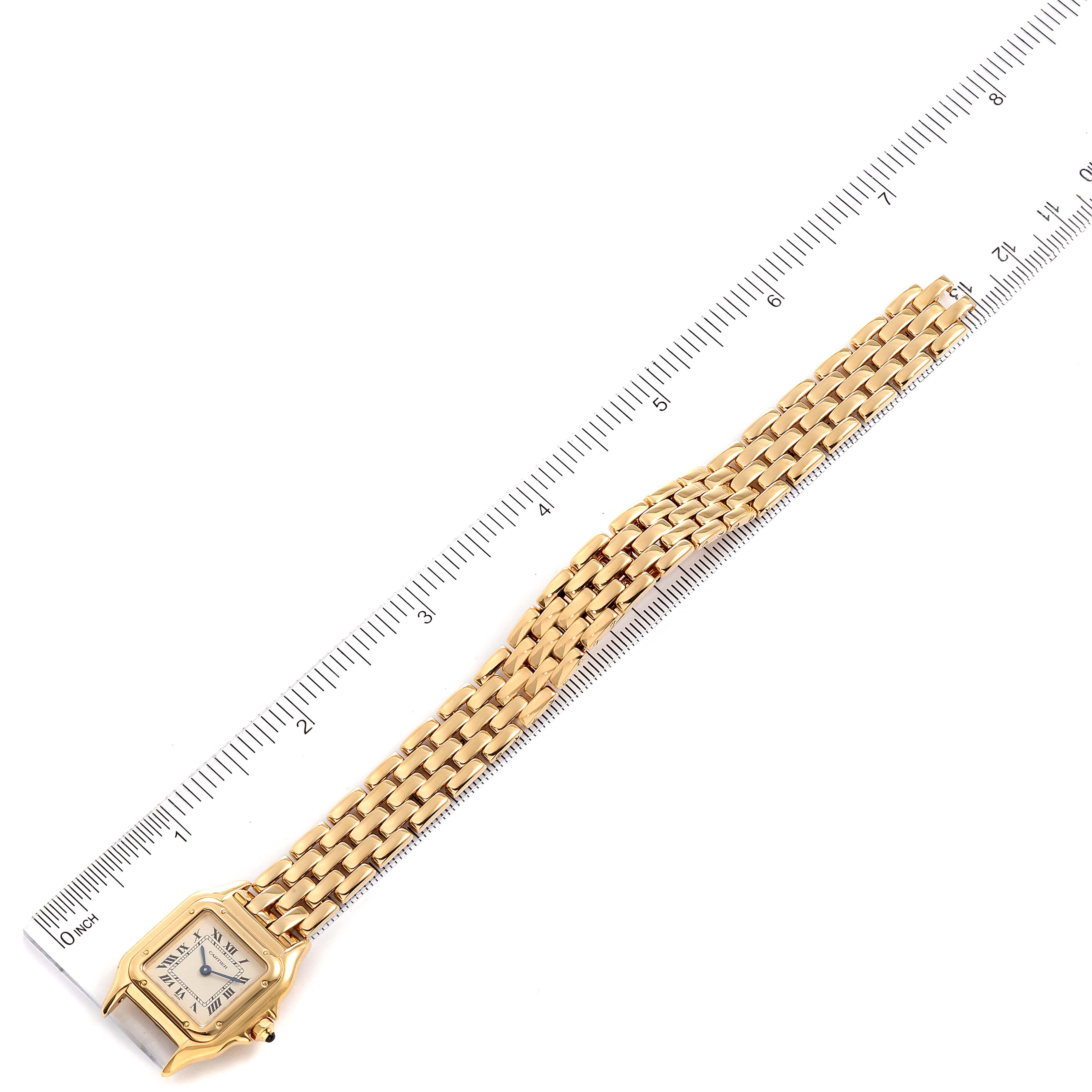 The Cartier Panthere W25022B9 Women's Yellow Gold Silver Dial W25022B9 Women's Yellow Gold Silver Dial watch is shown from a top-down angle with its face and full bracelet visible alongside a ruler for size reference.
