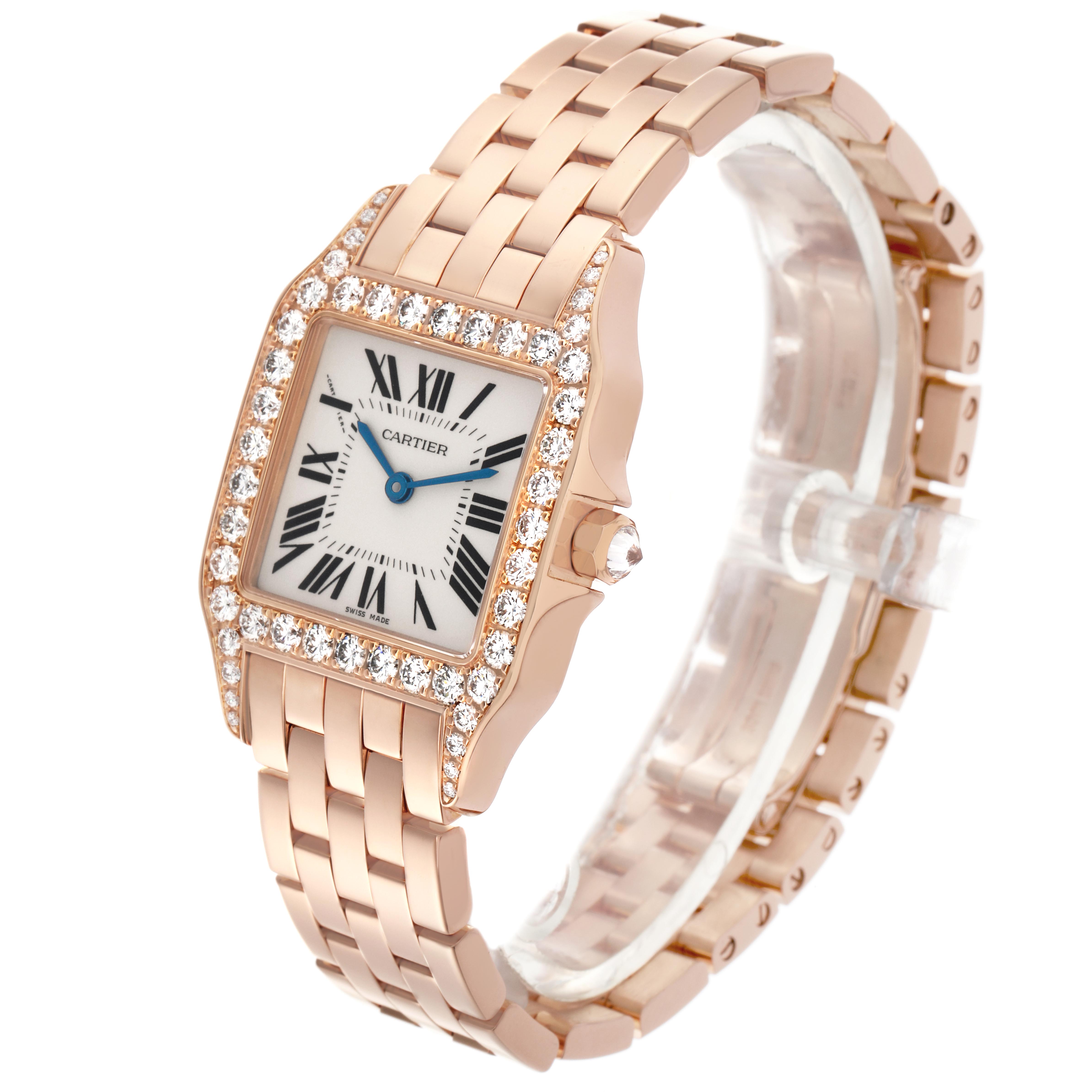 The Cartier Santos Demoiselle WF9007Z8 Women
s Rose Gold Silver Dial WF9007Z8 Women
s Rose Gold Silver Dial watch is shown at an angle highlighting the bracelet, bejeweled bezel, and dial with Roman numerals.